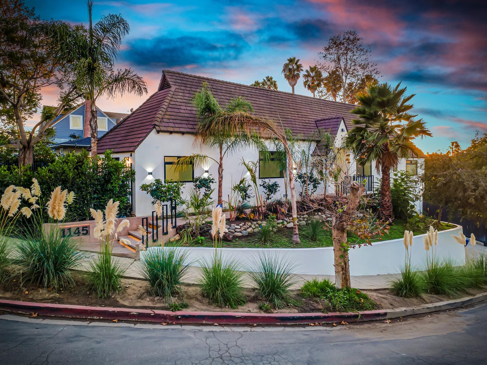 1145 S Longwood Ave — 1929 Spanish-style home in Mid-Wilshire at dusk