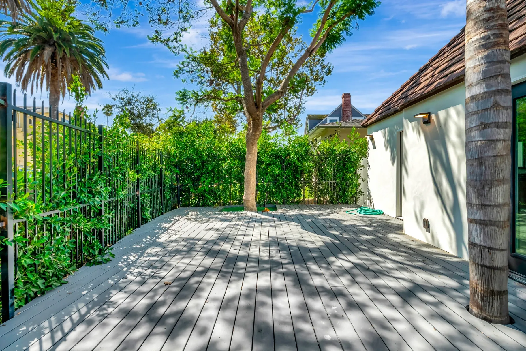 1145 S Longwood Ave Mid-Wilshire — Outdoor: Wooden deck with outdoor seating area and tropical landscaping