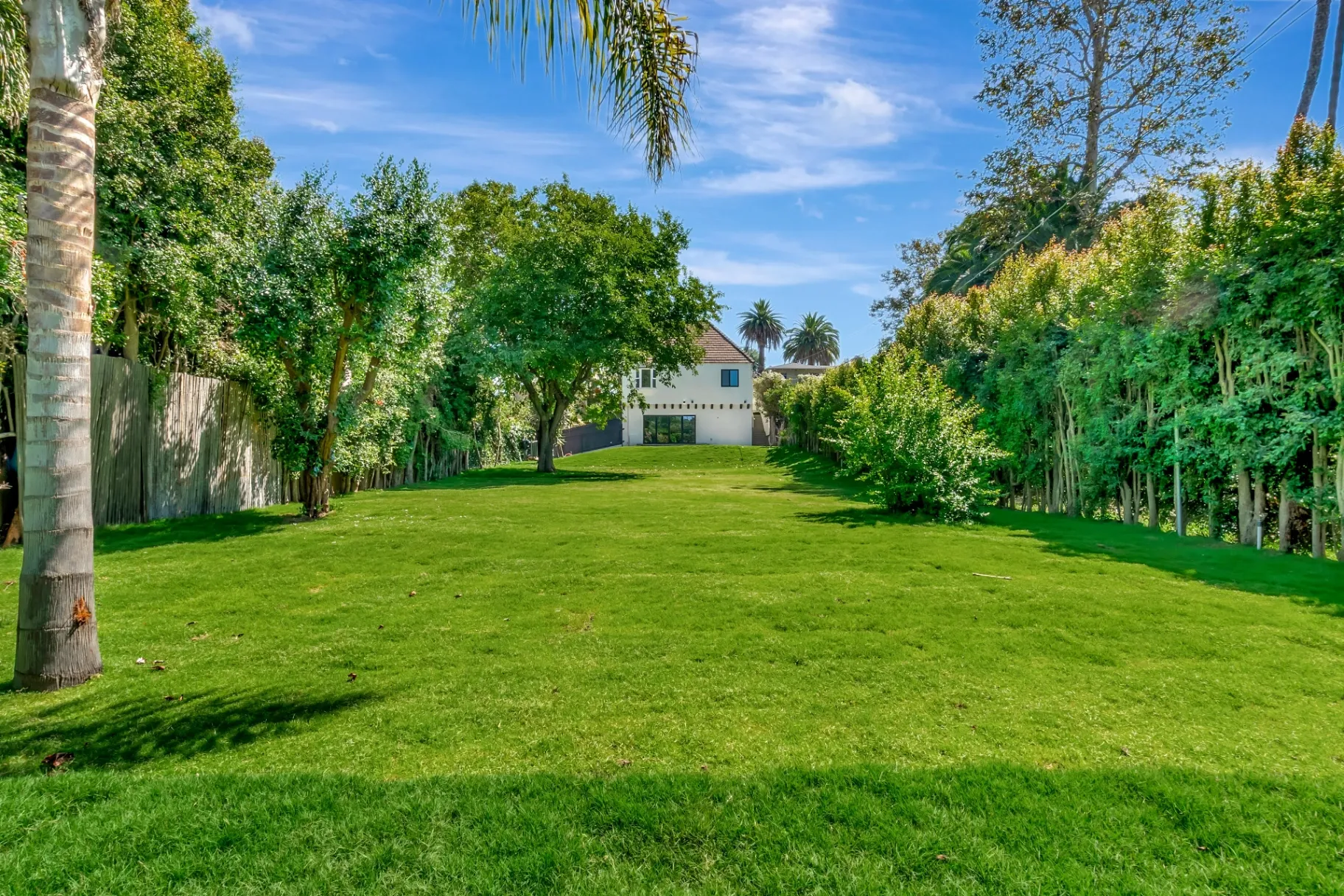 1145 S Longwood Ave Mid-Wilshire — Outdoor: Spacious backyard lawn area with Spanish-style home in background