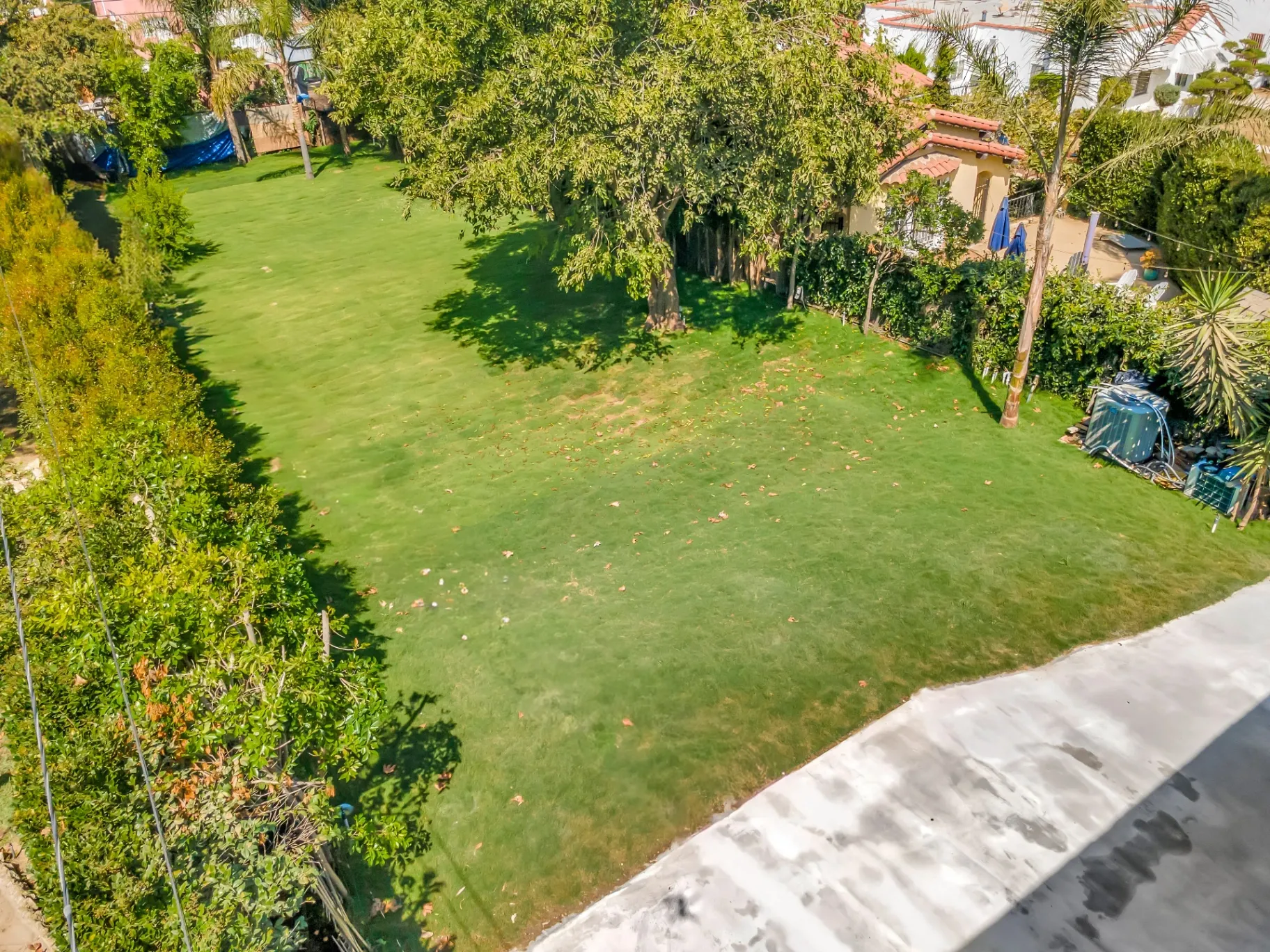 1145 S Longwood Ave Mid-Wilshire — Outdoor: Aerial perspective of large backyard lawn and outdoor entertainment area