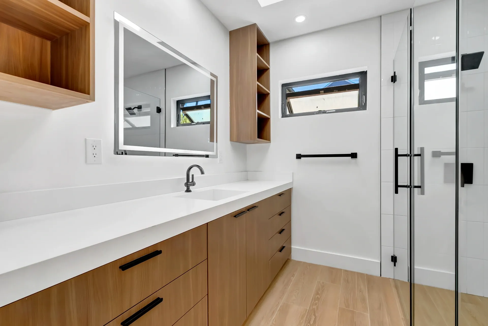 1145 S Longwood Ave Mid-Wilshire — Bathroom: Full bathroom with wood vanity, glass shower, and modern finishes