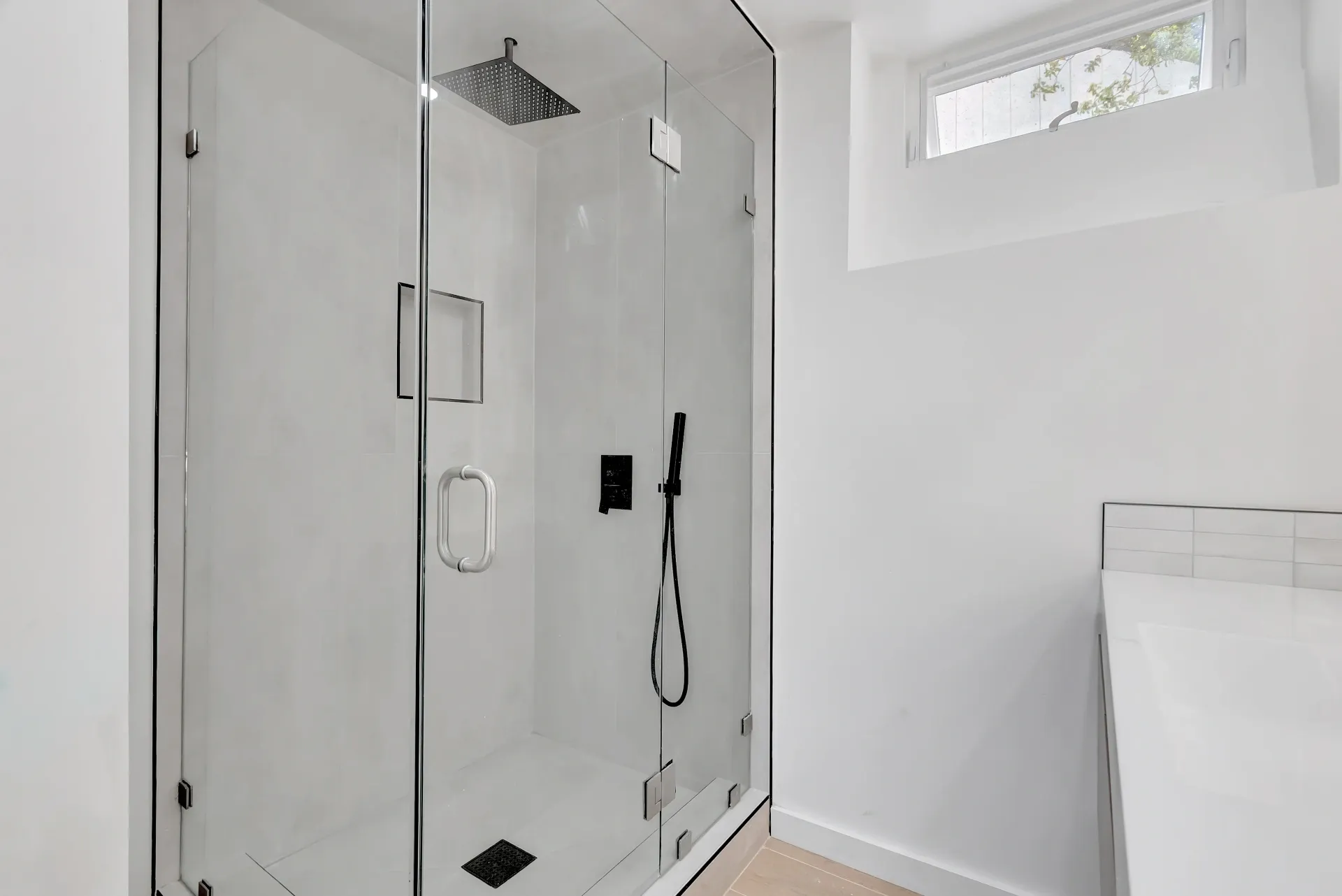1145 S Longwood Ave Mid-Wilshire — Bathroom: Spacious shower with glass enclosure and modern black hardware