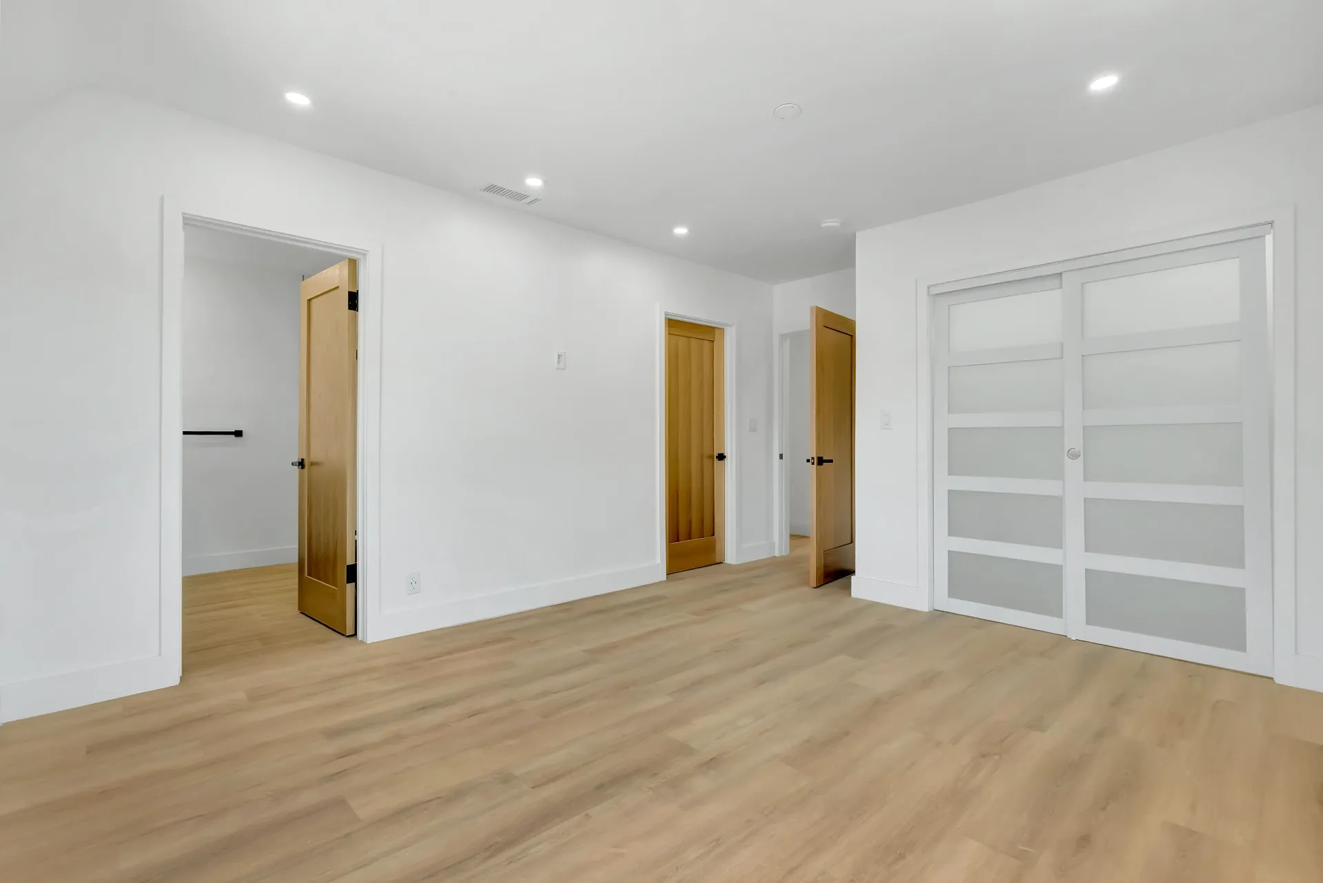 1145 S Longwood Ave Mid-Wilshire — Bedroom: Primary bedroom suite with multiple access doors and custom storage