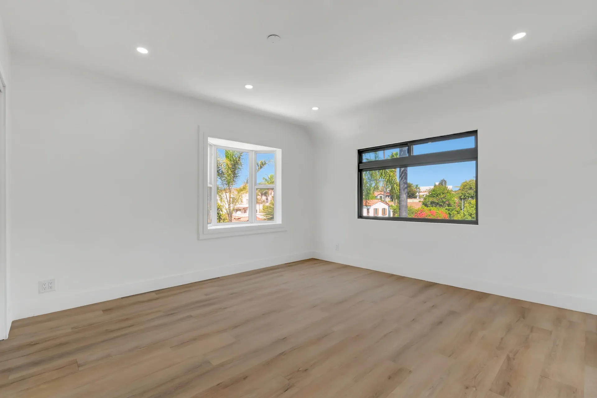 1145 S Longwood Ave Mid-Wilshire — Bedroom: Corner bedroom with dual windows and garden views
