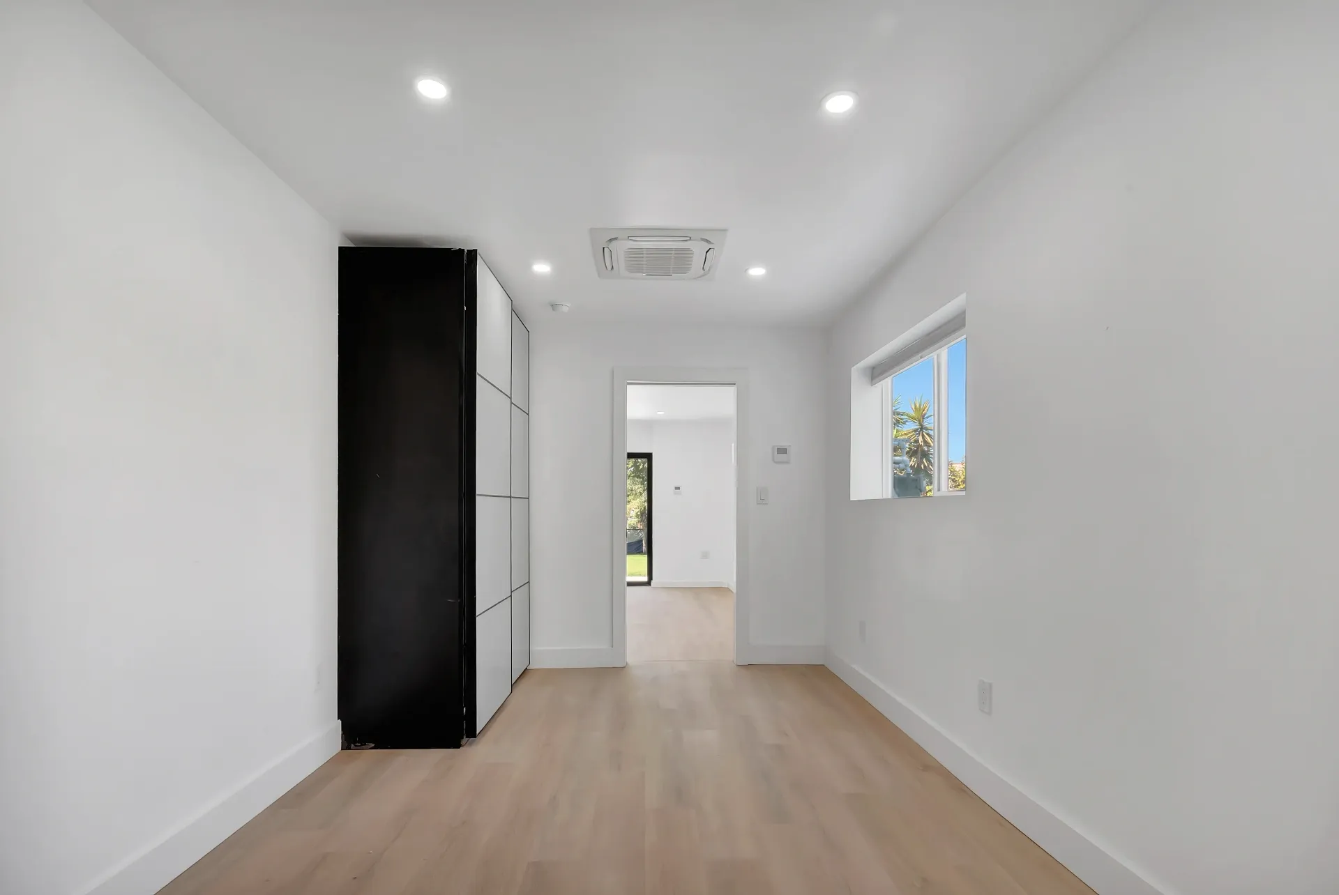 1145 S Longwood Ave Mid-Wilshire — Bedroom: Contemporary bedroom with built-in storage and window views