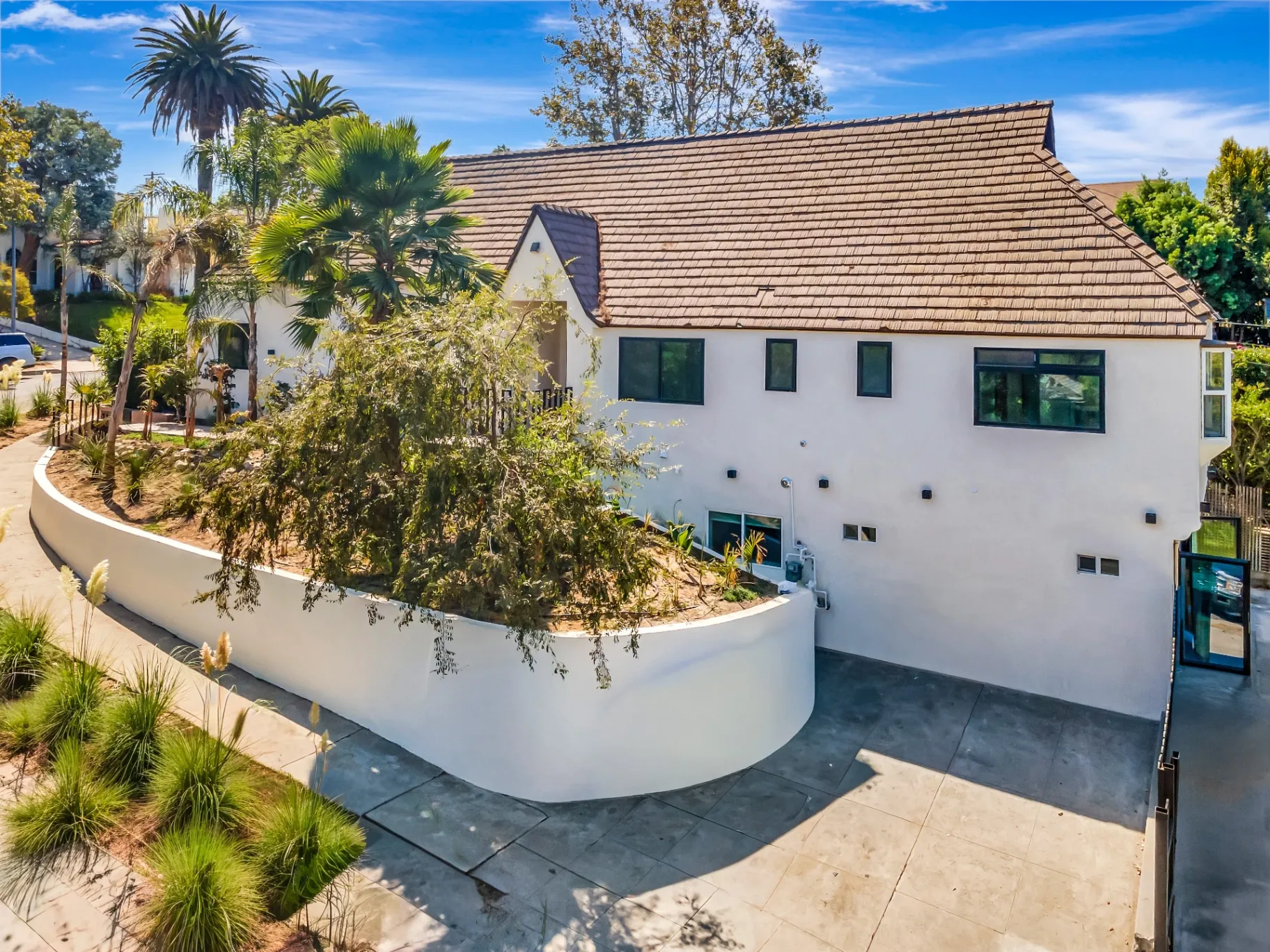 1145 S Longwood Ave Mid-Wilshire — Exterior: Modern entrance with wooden door and covered walkway