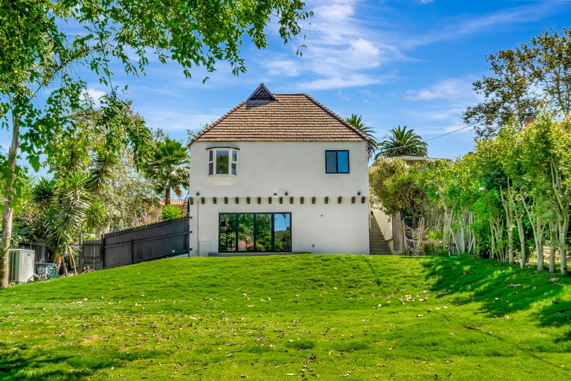 1145 S Longwood Ave Mid-Wilshire — Exterior: Backyard view with large lawn and mature landscaping