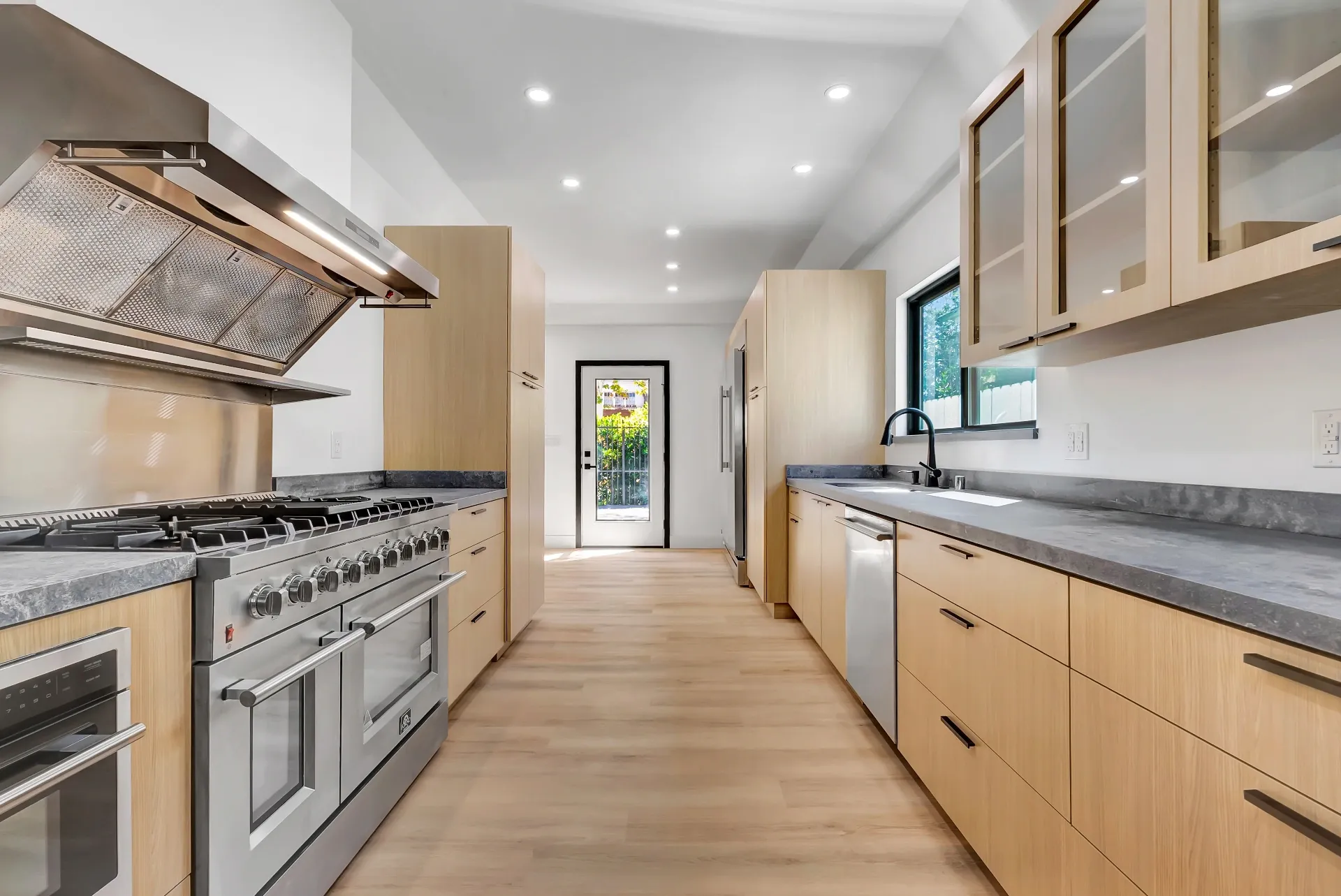 1145 S Longwood Ave Mid-Wilshire — Kitchen: Galley-style kitchen with dual sinks and high-end stainless steel appliances