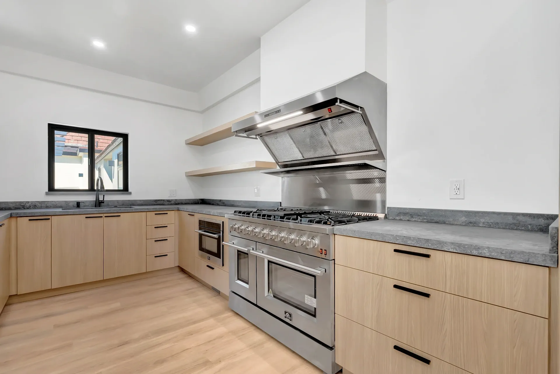 1145 S Longwood Ave Mid-Wilshire — Kitchen: Modern kitchen featuring wood cabinets and commercial-grade cooking equipment