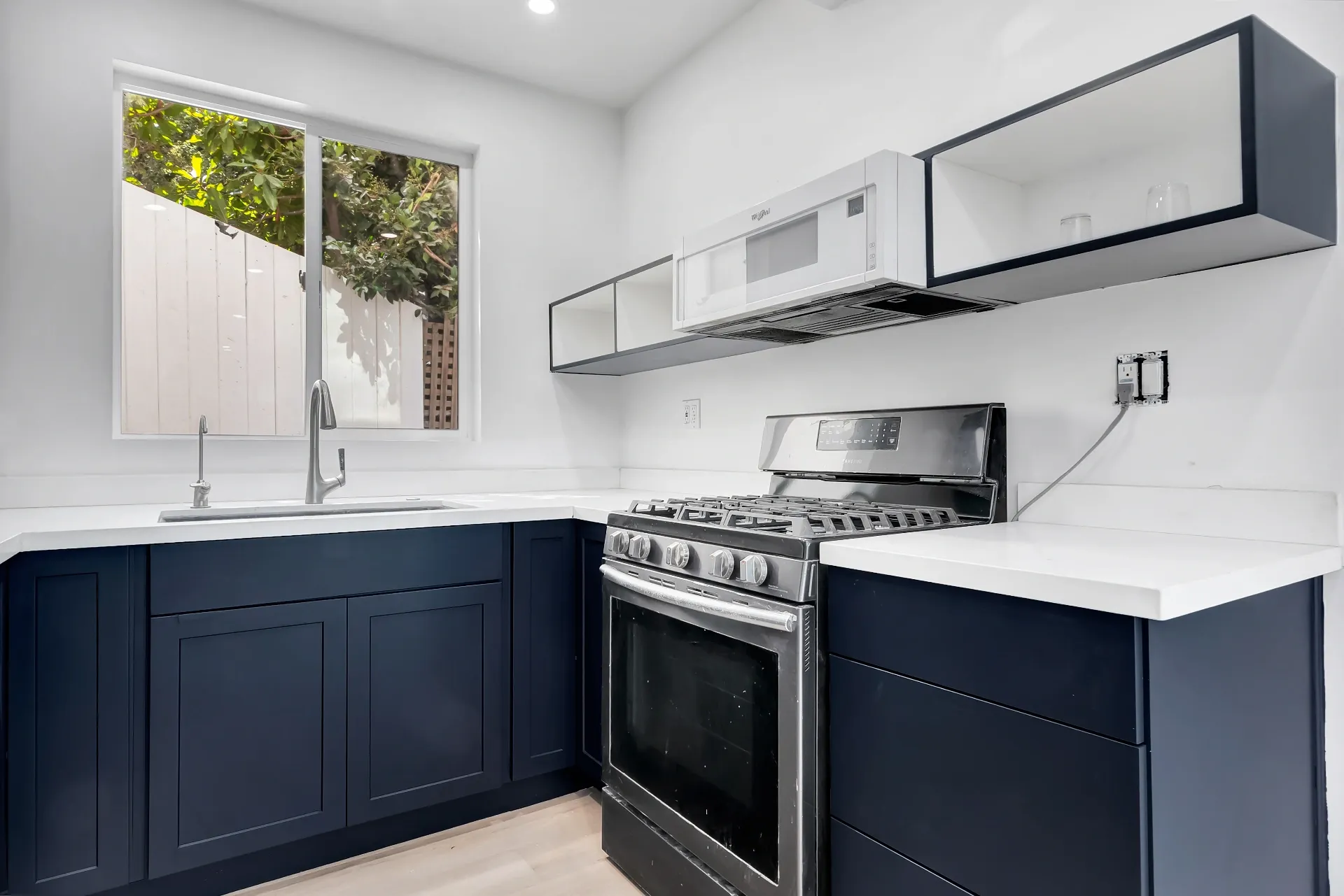 1145 S Longwood Ave Mid-Wilshire — Kitchen: Secondary kitchen with navy cabinetry and white quartz countertops
