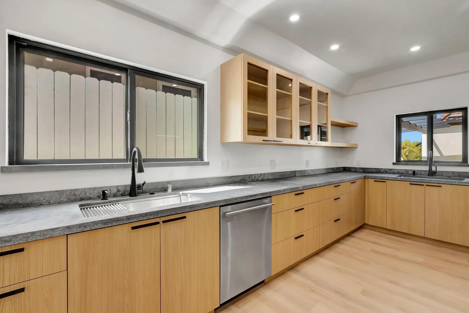 1145 S Longwood Ave Mid-Wilshire — Kitchen: L-shaped kitchen with wood cabinetry, granite counters, and glass-front upper cabinets
