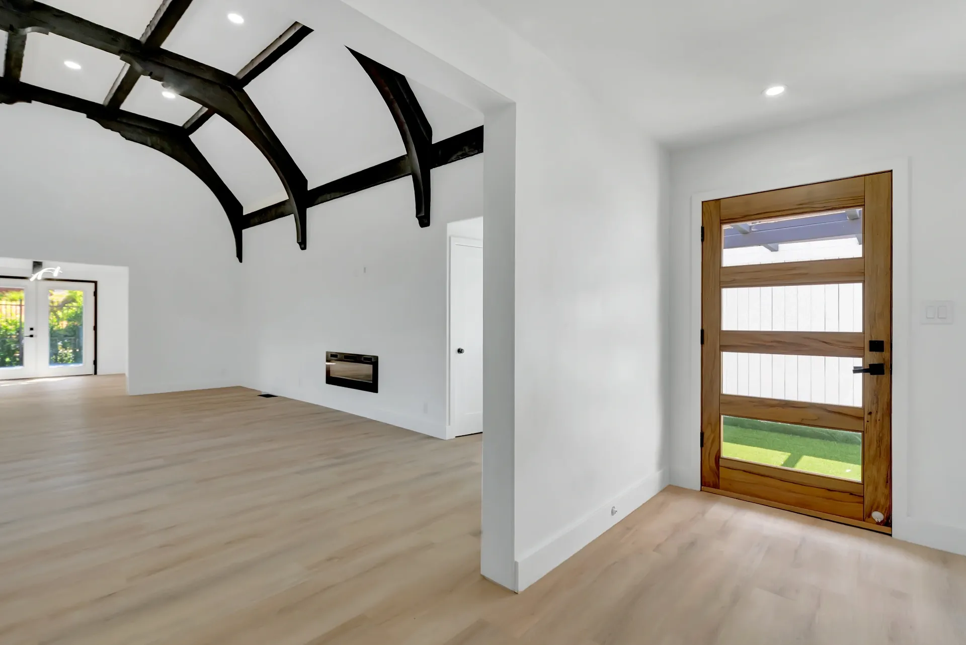 1145 S Longwood Ave Mid-Wilshire — Living: Spanish-style living room with exposed wood beam ceiling and built-in fireplace