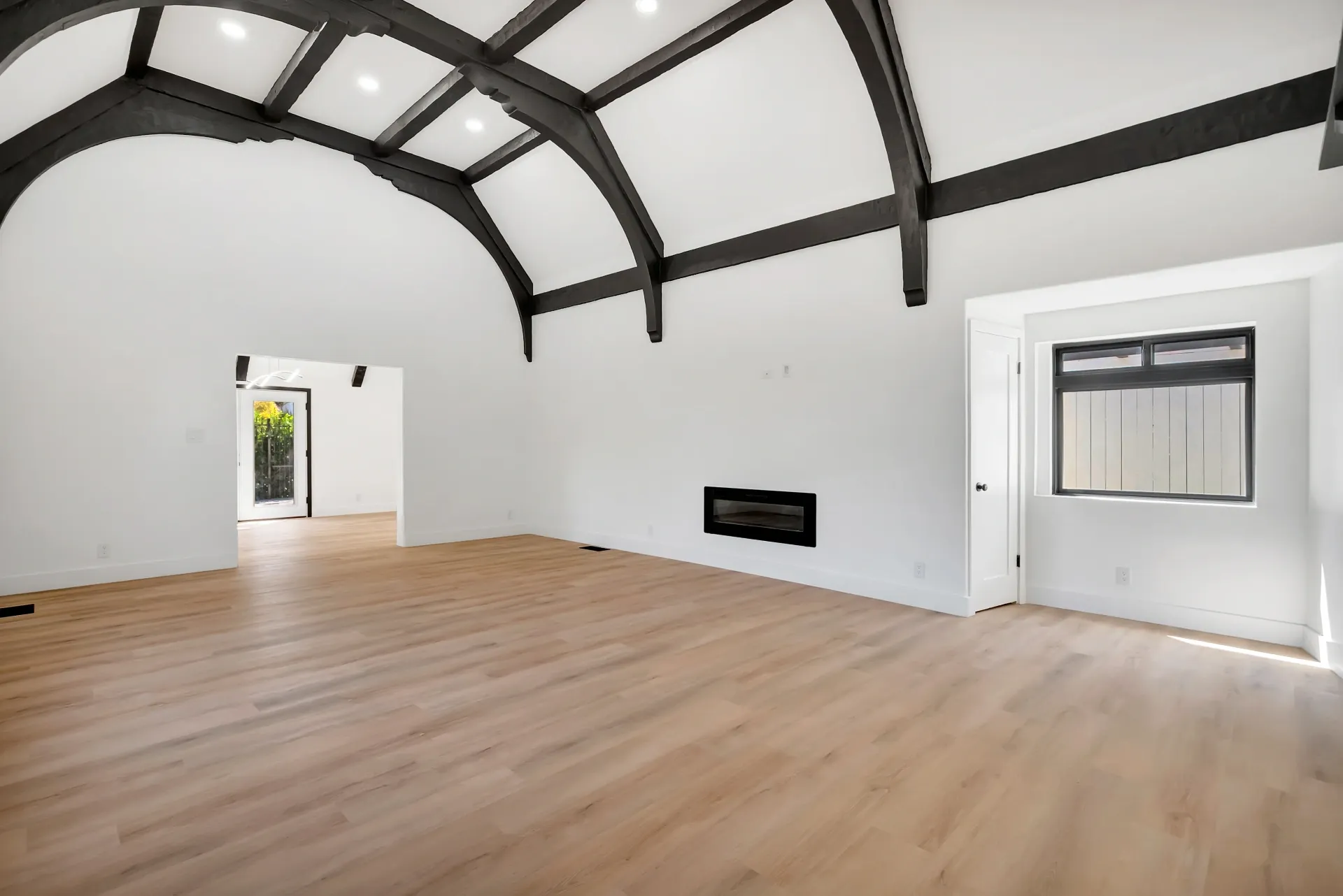 1145 S Longwood Ave Mid-Wilshire — Living: Open living area with architectural beams and modern fireplace