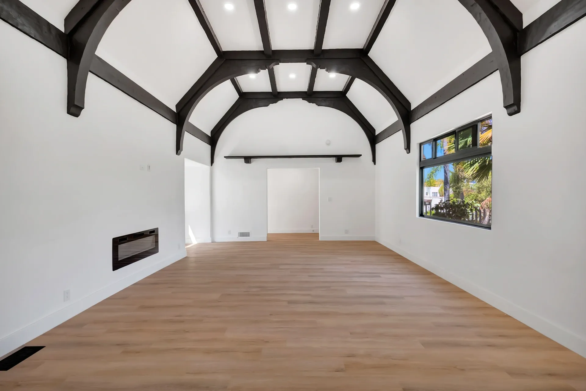 1145 S Longwood Ave Mid-Wilshire — Living: Living room with exposed ceiling beams and large windows