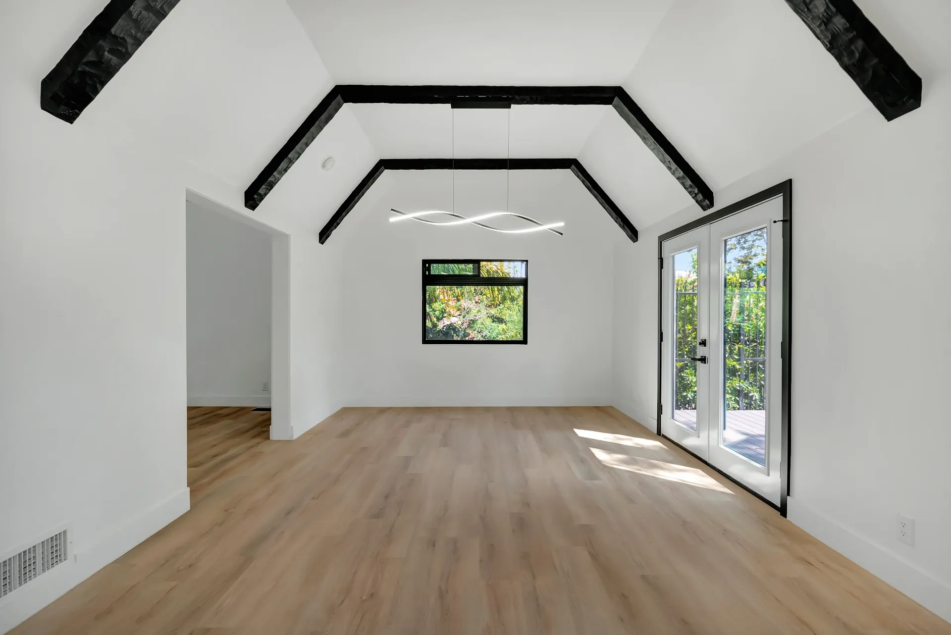 1145 S Longwood Ave Mid-Wilshire — Living: Contemporary dining room with exposed beams and pendant lighting
