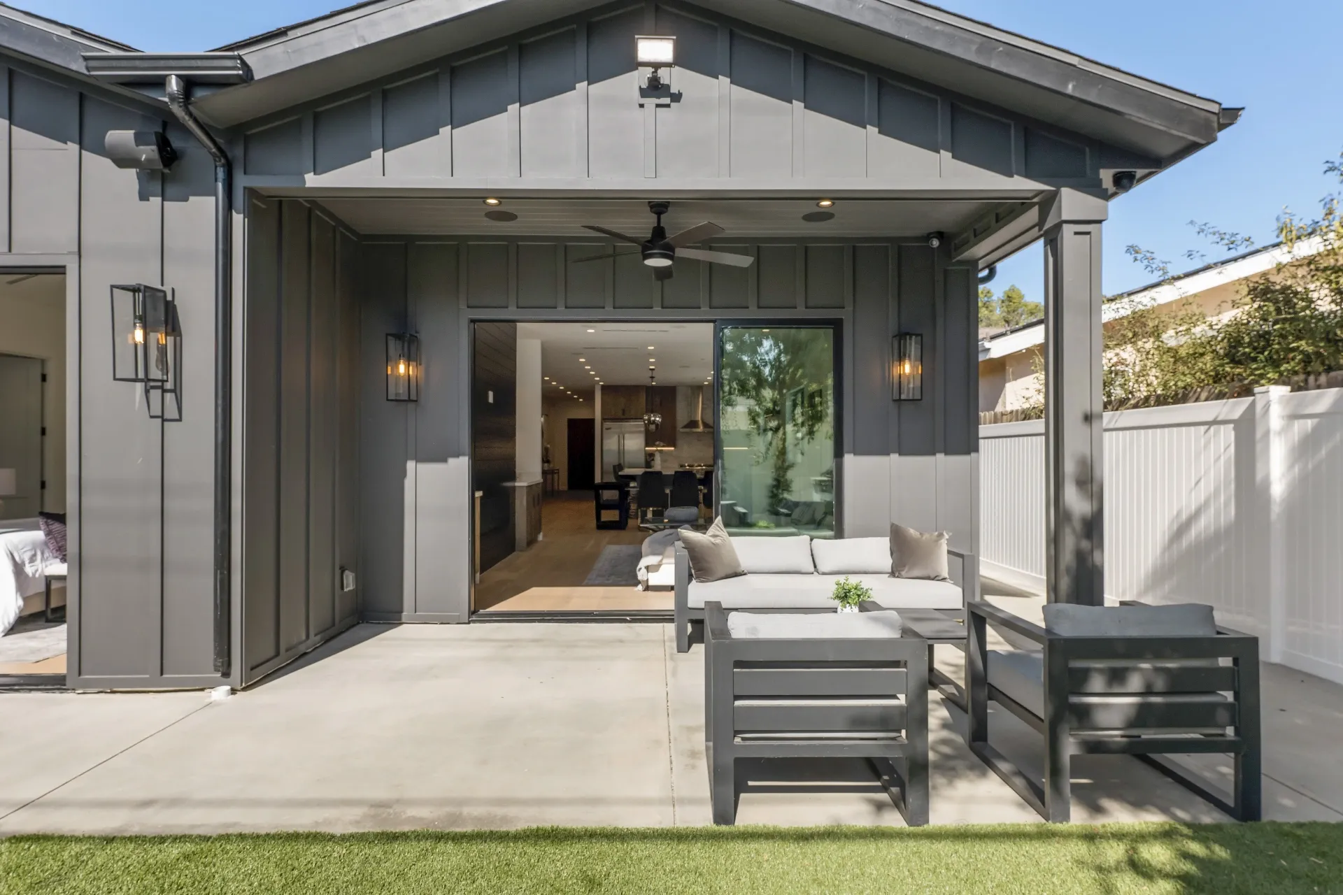 14602 Morrison St — Backyard: Covered outdoor living area with contemporary sectional seating and modern outdoor dining set