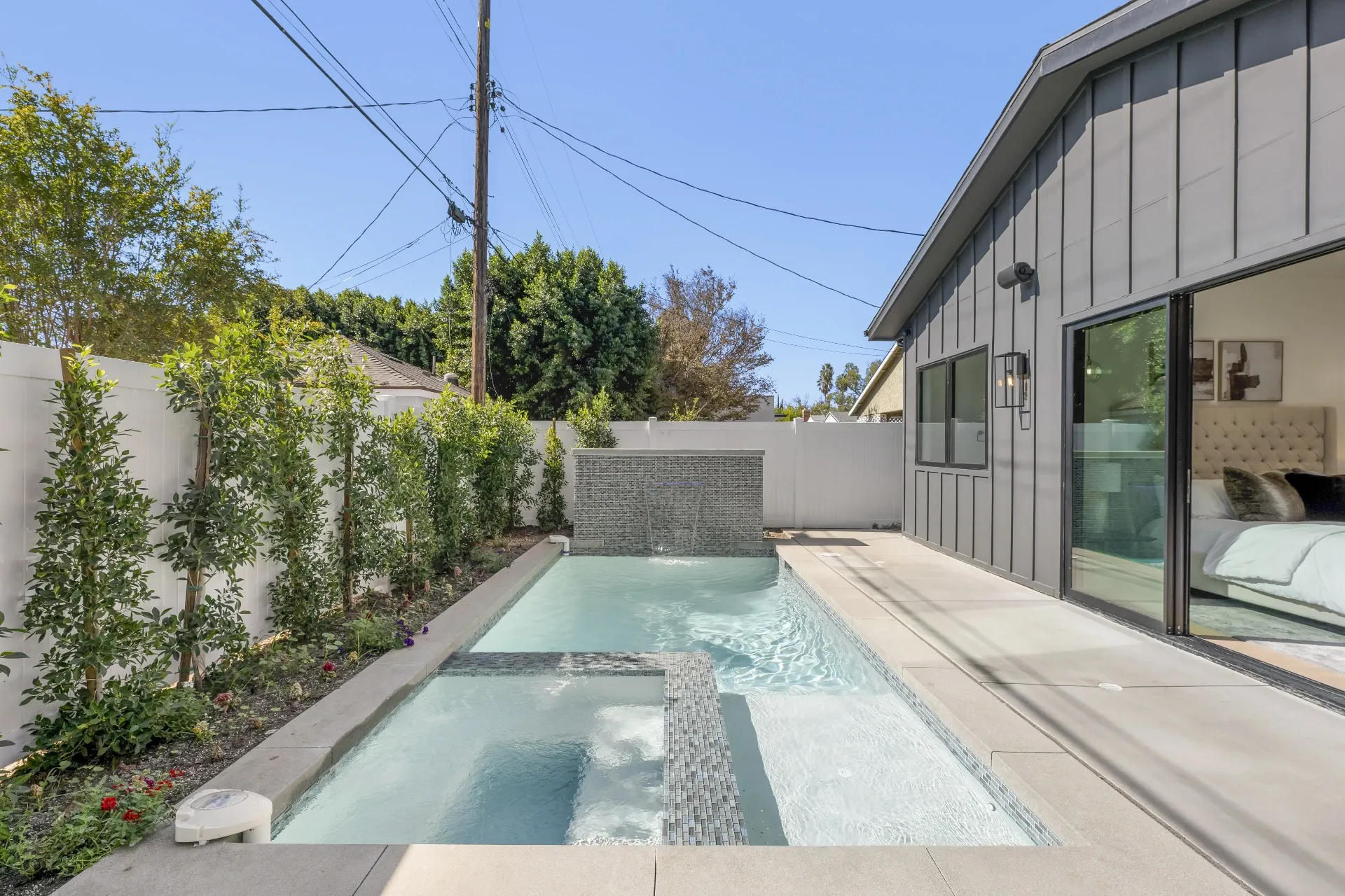 14602 Morrison St — Backyard: Daytime pool view showcasing blue water, spa integration, and professionally landscaped backyard