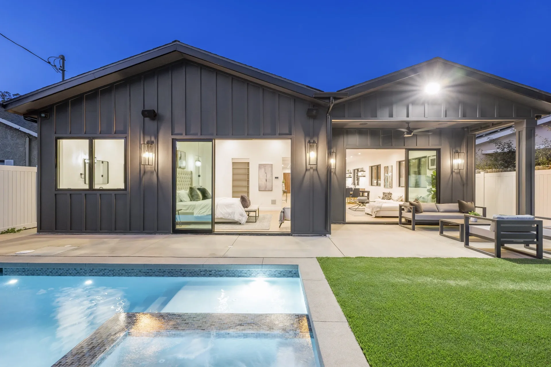 14602 Morrison St — Backyard: Twilight view of modern farmhouse with illuminated pool and outdoor entertainment spaces