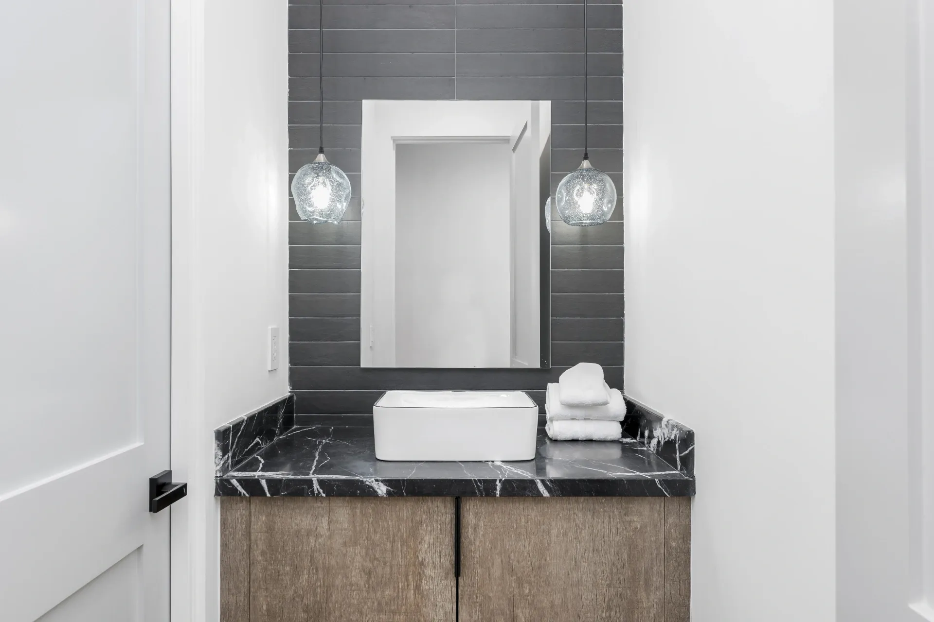 14602 Morrison St — Bathrooms: Powder room with vessel sink, dark tile accent wall, and pendant lighting