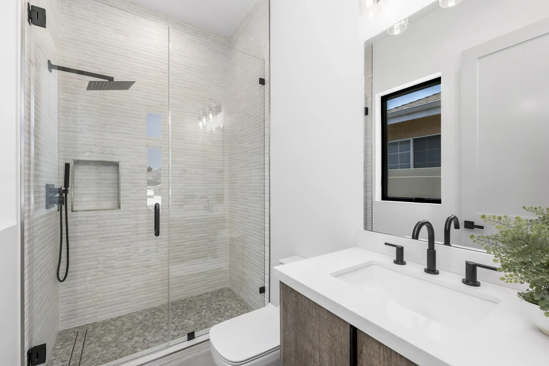 14602 Morrison St — Bathrooms: Walk-in shower with herringbone tile pattern and frameless glass enclosure