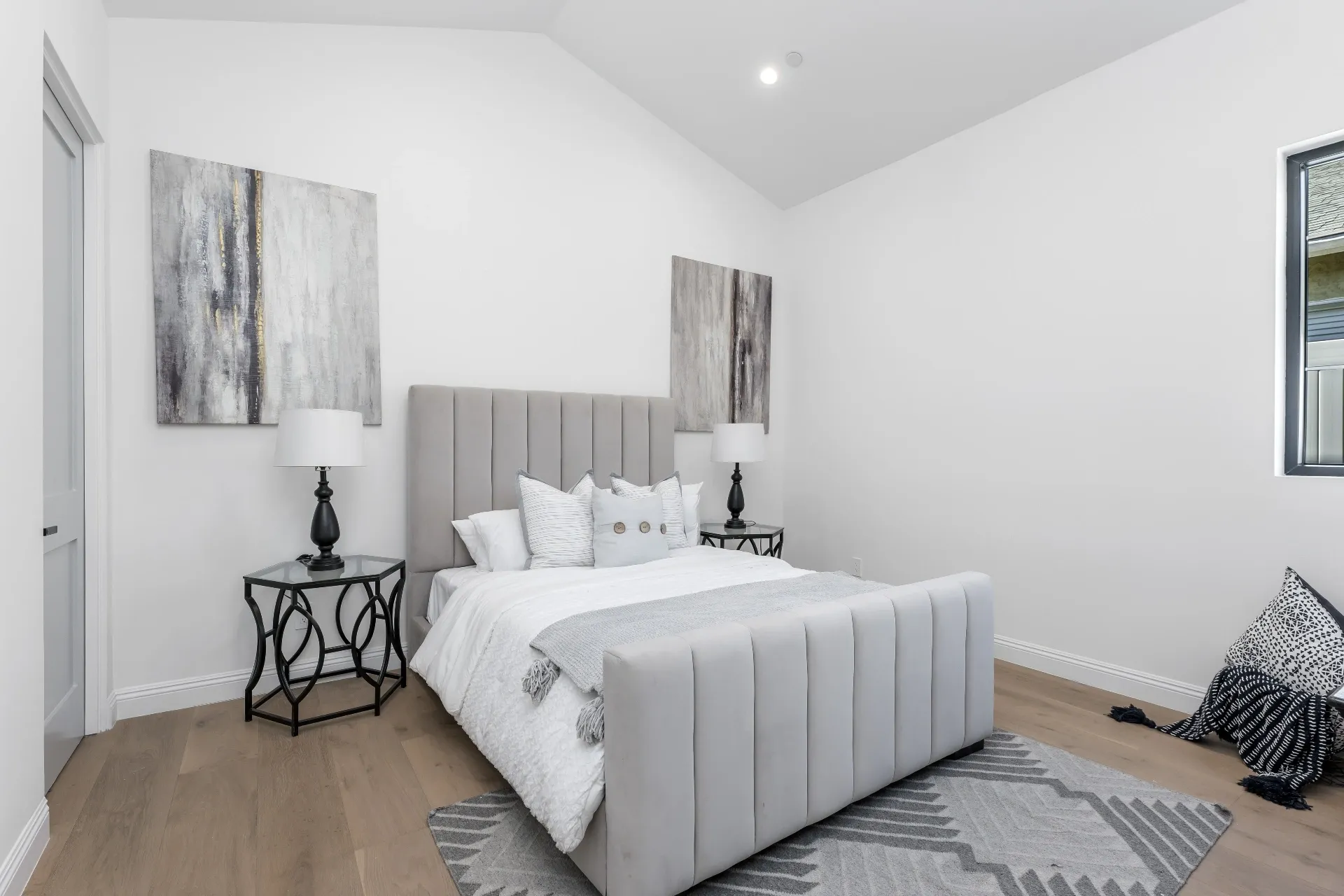 14602 Morrison St — Bedrooms: Guest bedroom with gray upholstered headboard and modern artwork