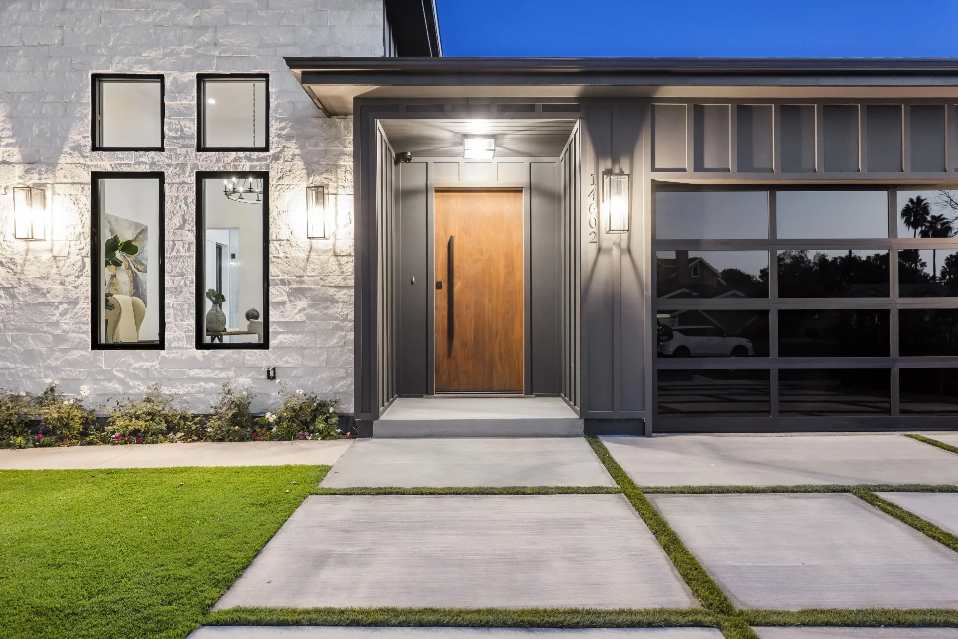 14602 Morrison St — Exterior: Close-up view of entrance with stone wall, wood door, and modern lighting fixtures
