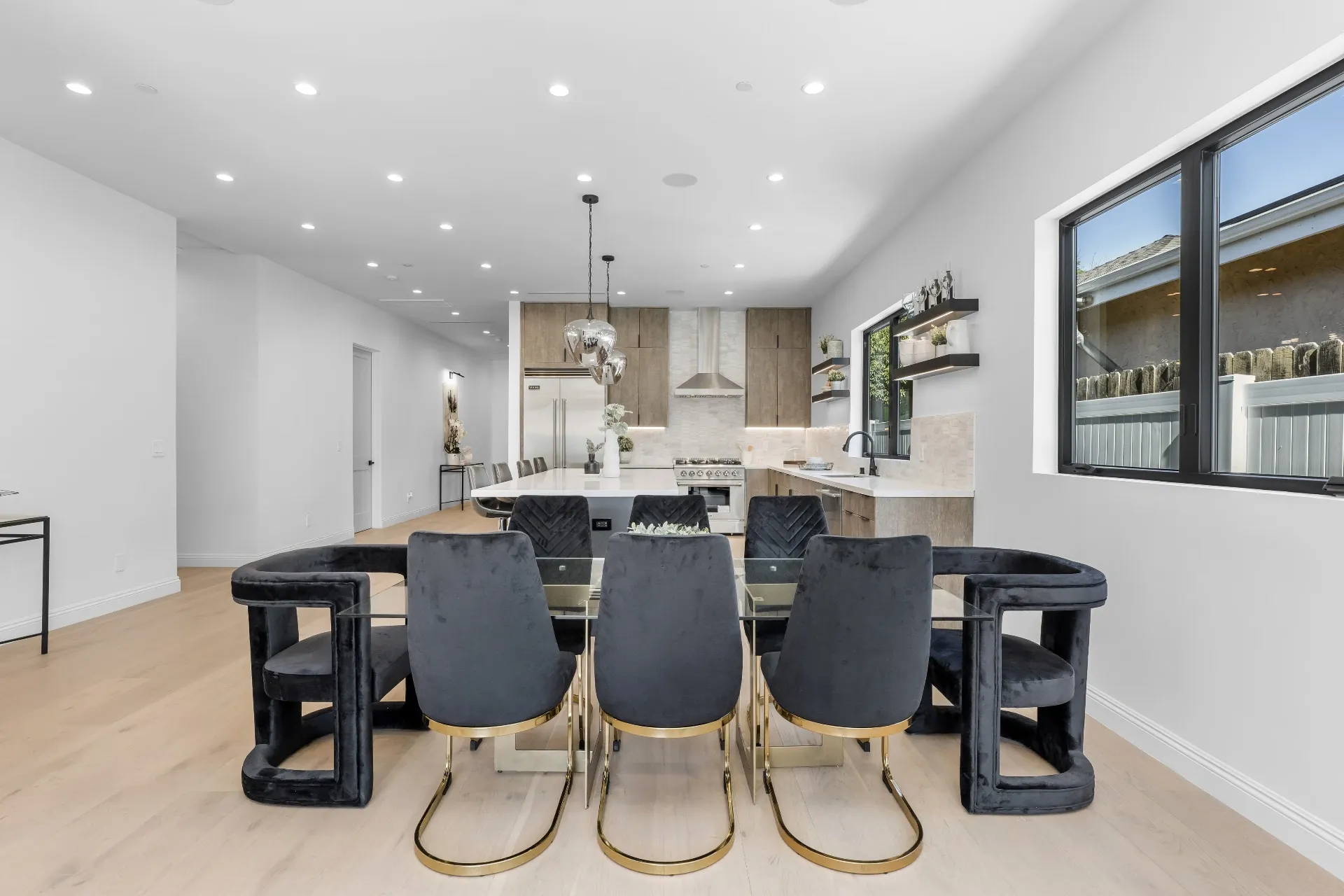 14602 Morrison St — Kitchen: Open kitchen with large island, chrome pendant lights, and contemporary dining area