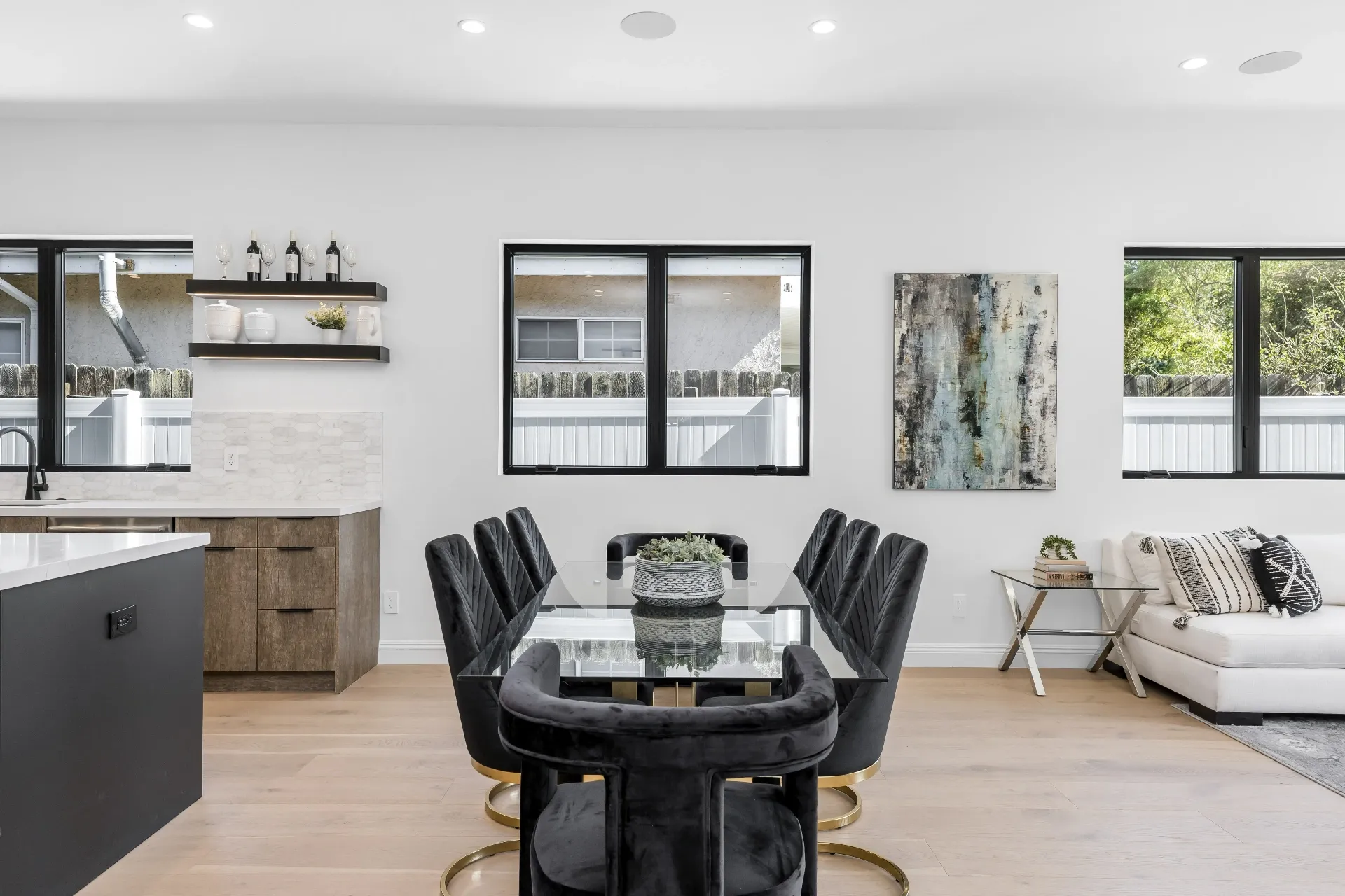 14602 Morrison St — Kitchen: Kitchen dining area with glass table, velvet chairs, and floating shelves