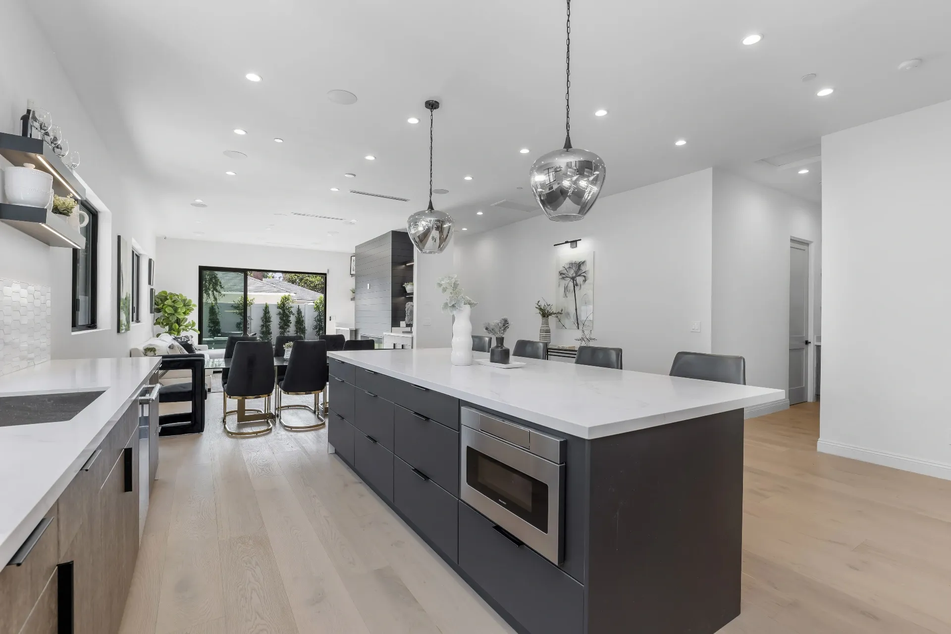 14602 Morrison St — Kitchen: Spacious kitchen island with dark gray base and white quartz countertops