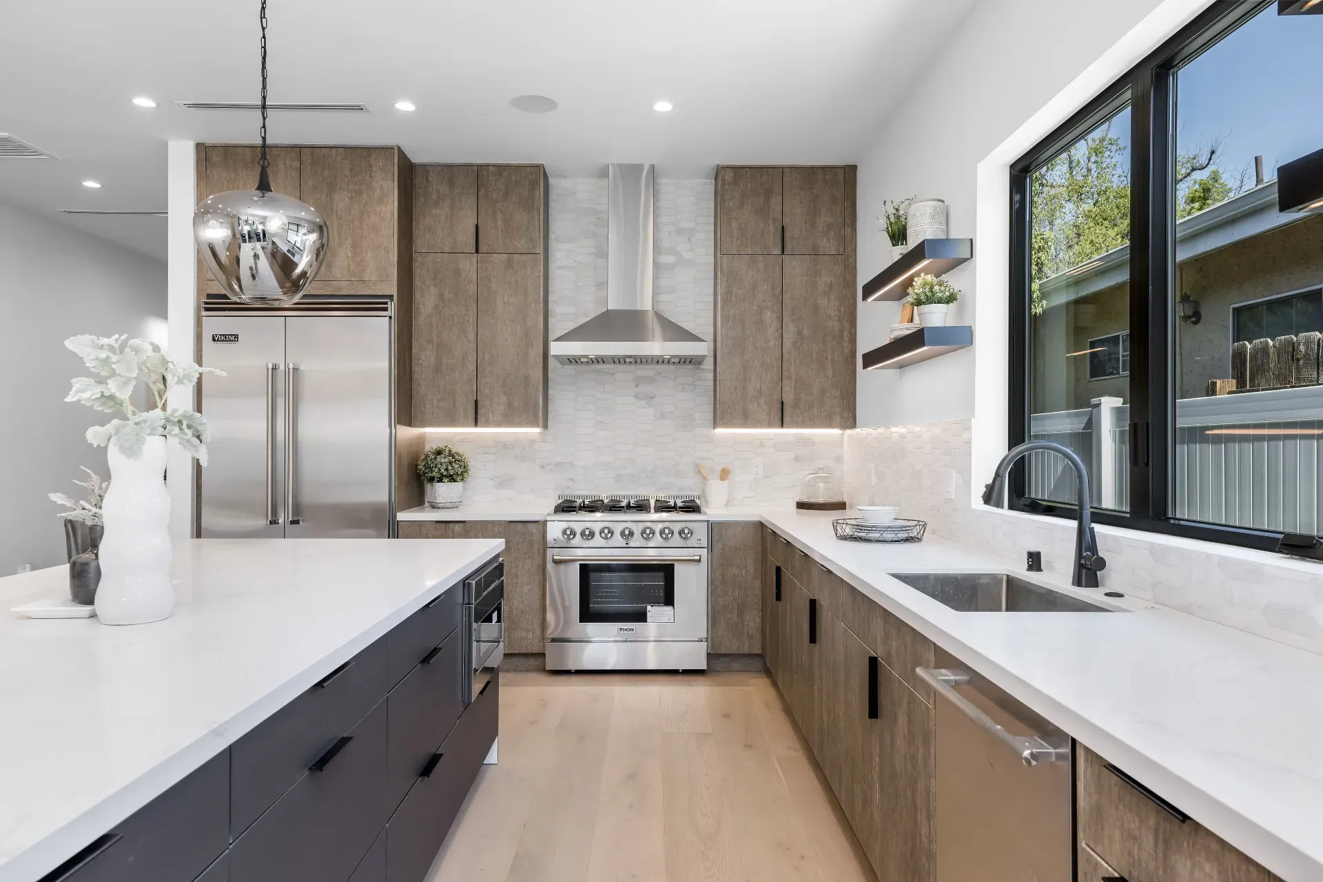 14602 Morrison St — Kitchen: Chef's kitchen with THOR range, chrome pendant light, and marble backsplash