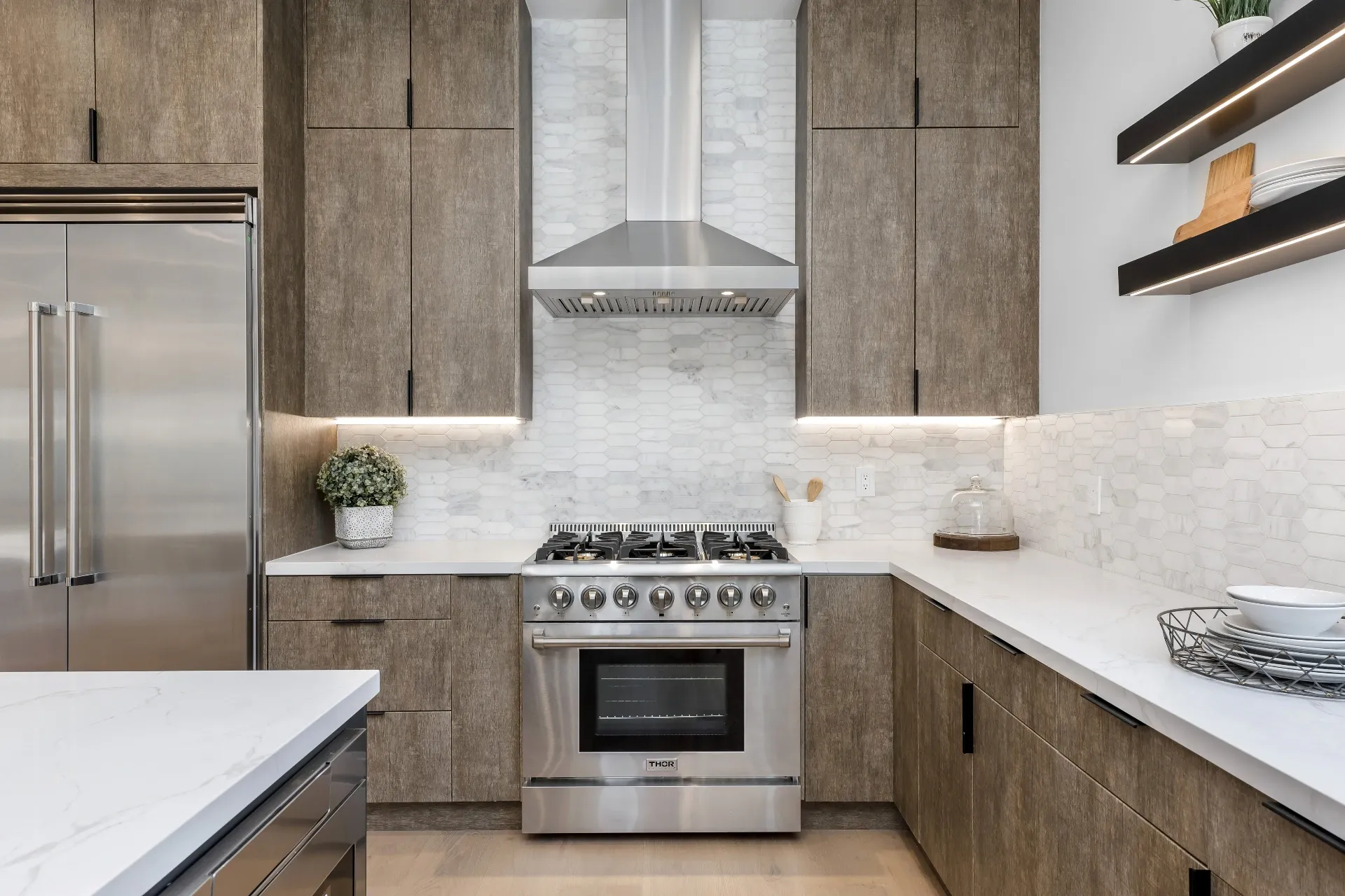 14602 Morrison St — Kitchen: Kitchen range wall with wood cabinets, under-cabinet lighting, and THOR appliances