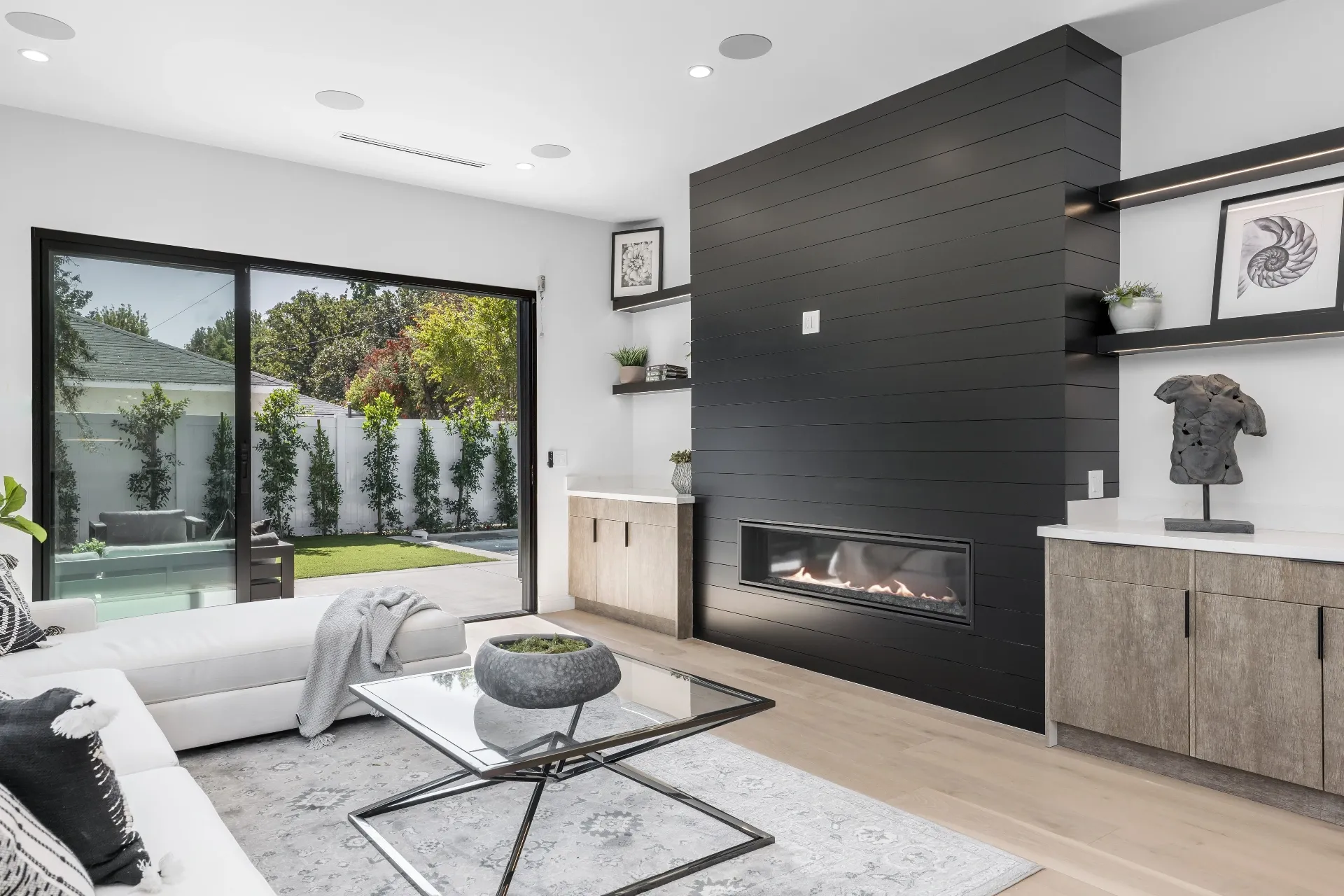 14602 Morrison St — Living Areas: Great room with horizontal fireplace, floating shelves, and pool views