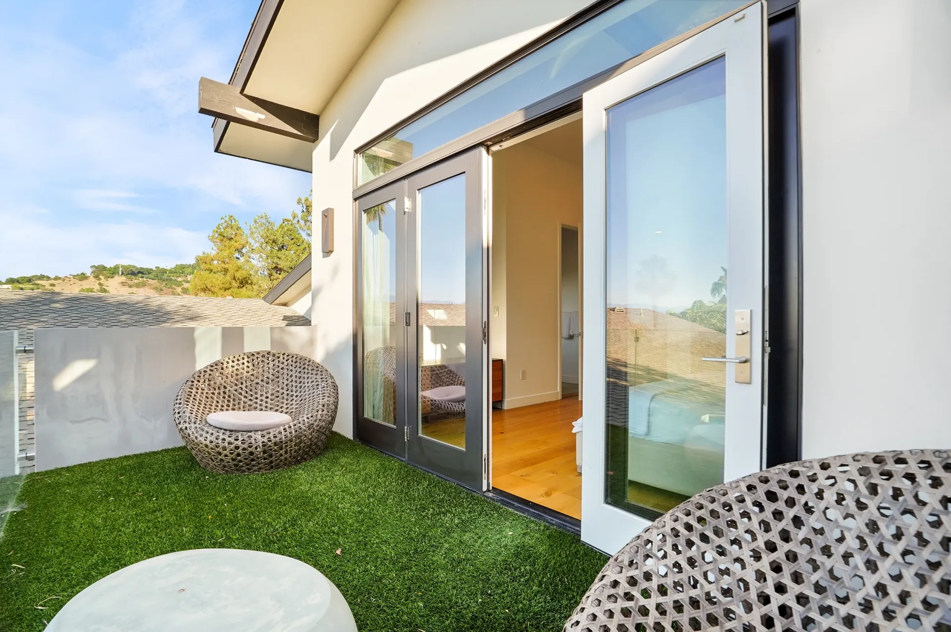 11308 Dona Teresa Dr — Backyard: Upper level balcony with wicker seating and sliding glass doors to indoor living spaces