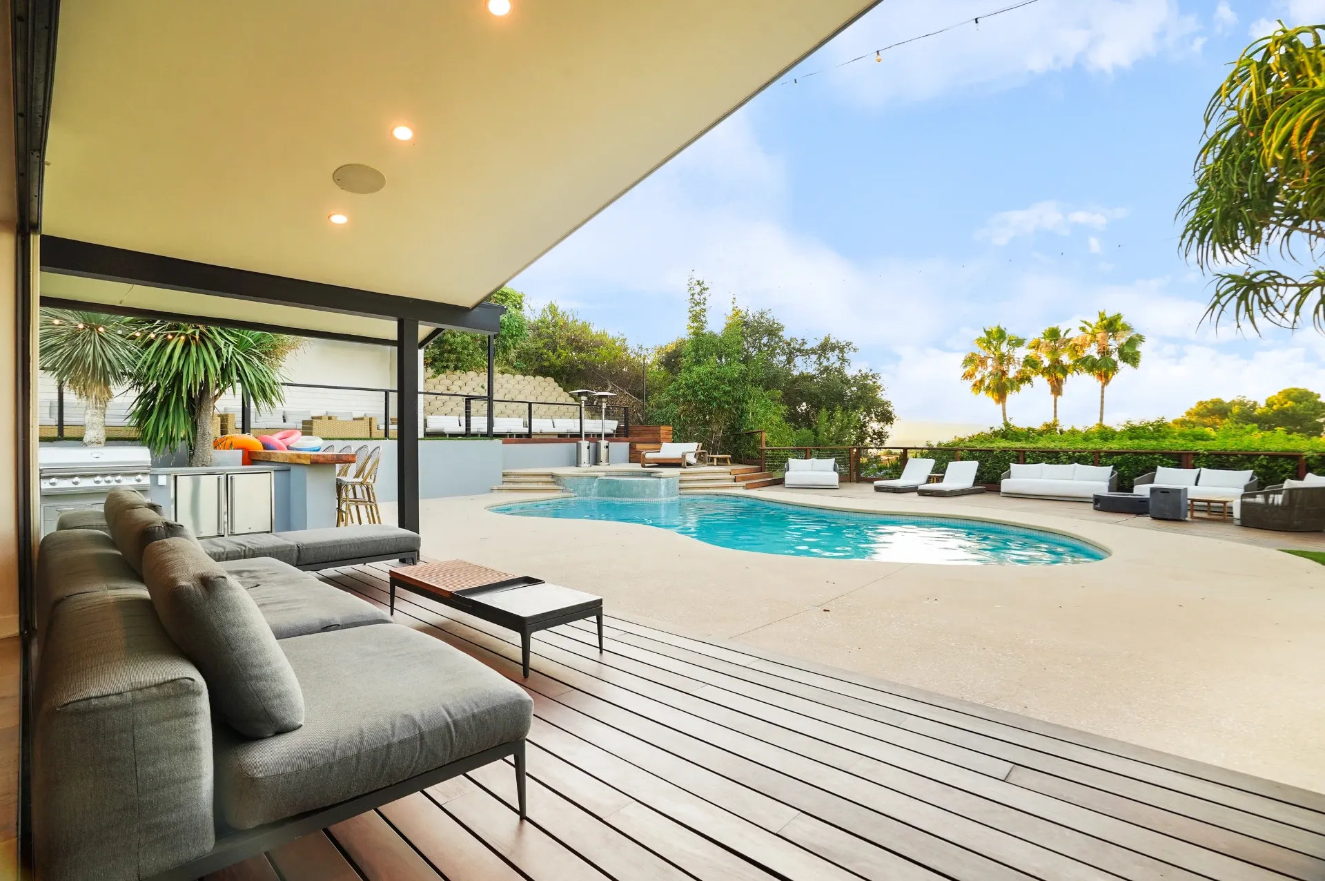 11308 Dona Teresa Dr — Backyard: Covered outdoor living room with sectional seating and seamless pool views under vaulted ceiling