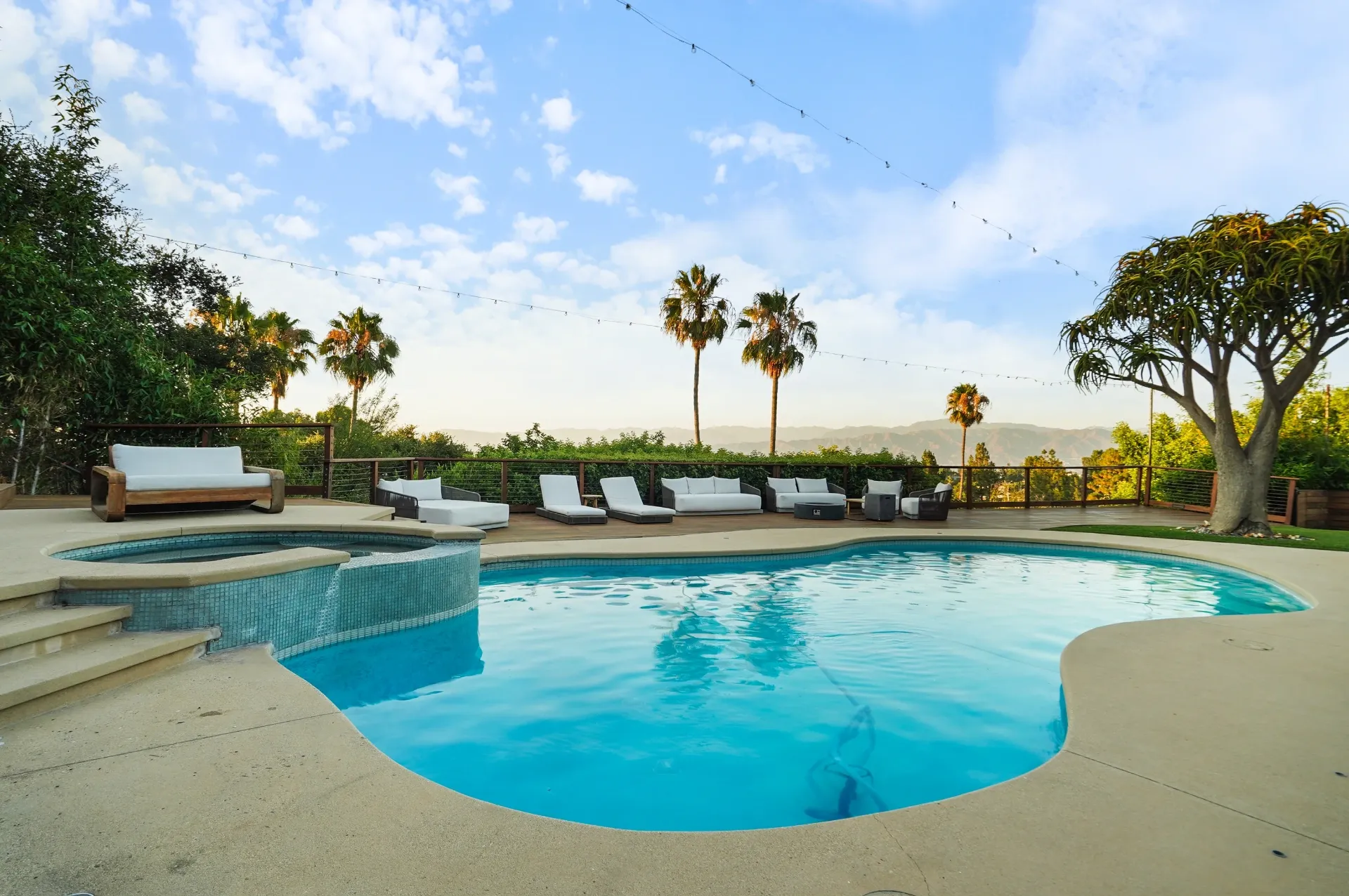 11308 Dona Teresa Dr — Backyard: Evening pool and spa with illuminated water features and panoramic valley views