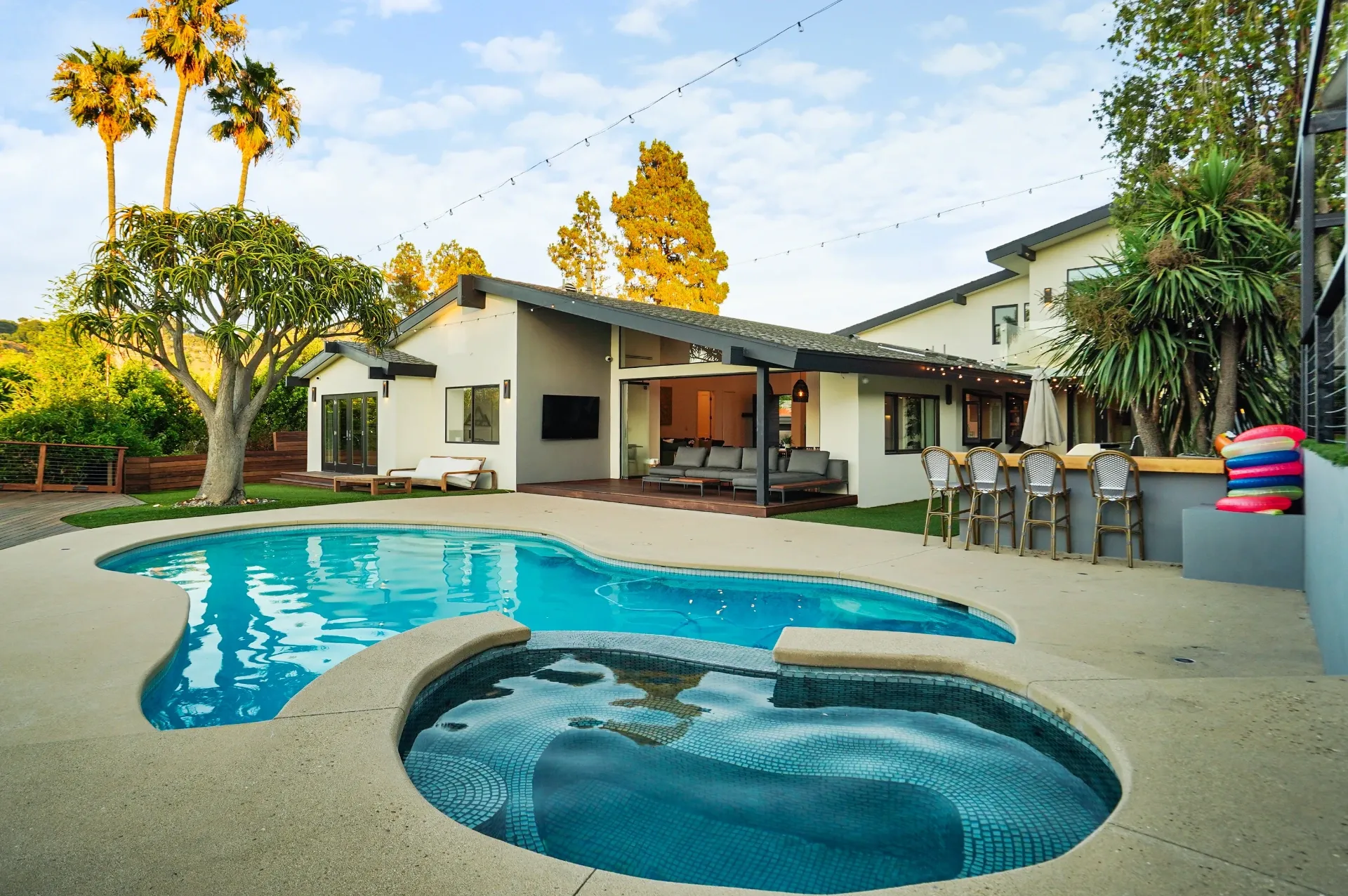 11308 Dona Teresa Dr — Backyard: Pool and spa area with outdoor dining and string lights creating warm evening ambiance