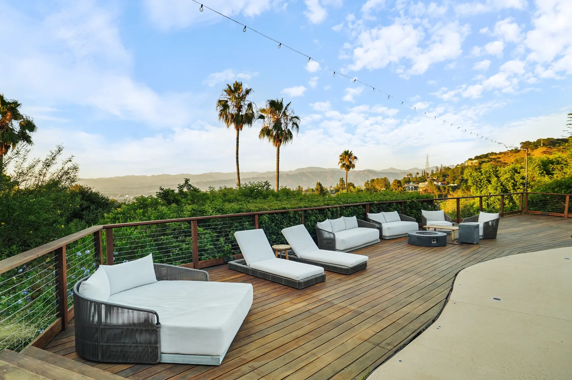 11308 Dona Teresa Dr — Backyard: Elevated deck lounge area with panoramic mountain views and modern outdoor furniture