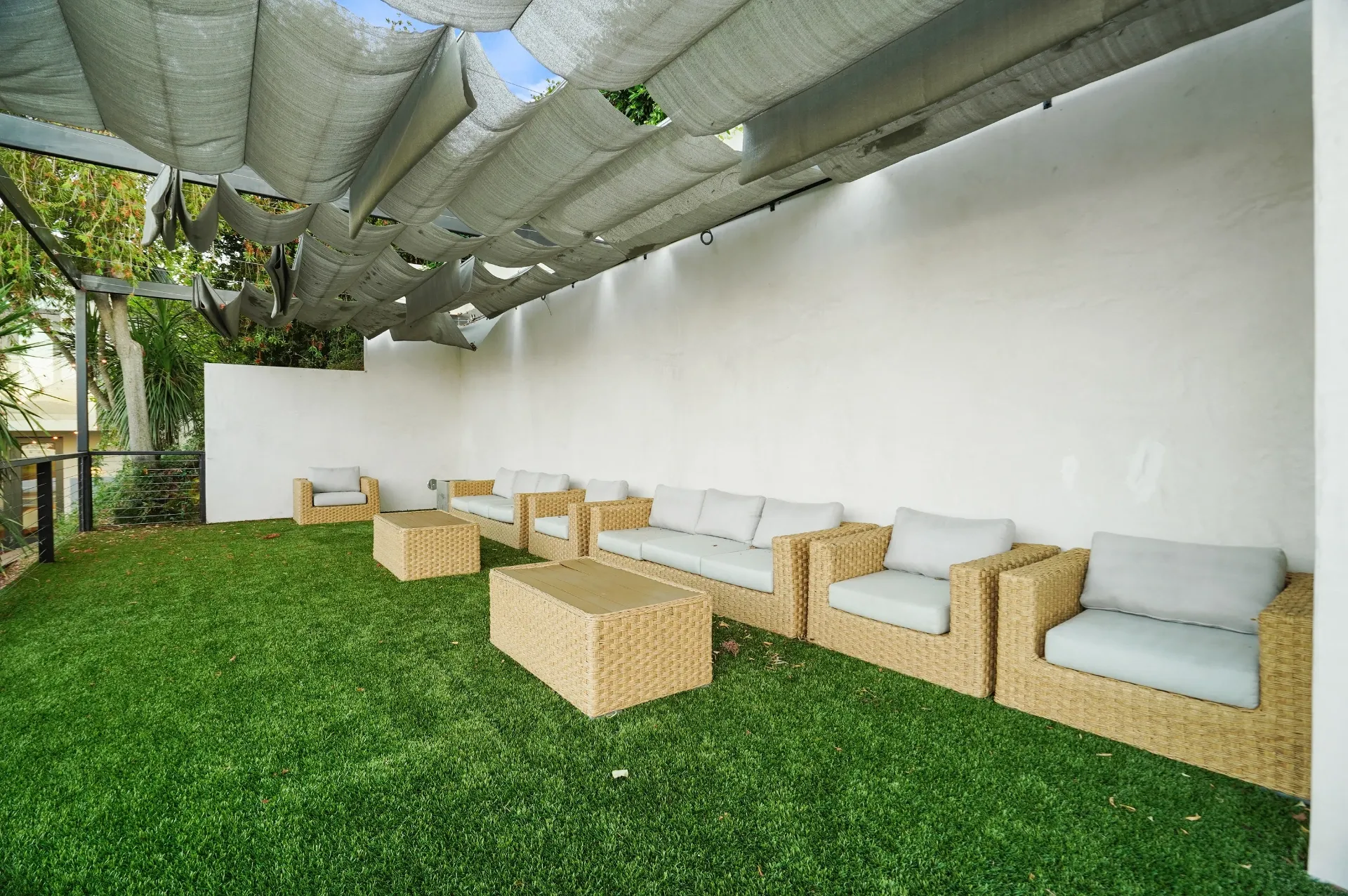 11308 Dona Teresa Dr — Backyard: Covered outdoor lounge with wicker furniture on artificial grass under shade canopy