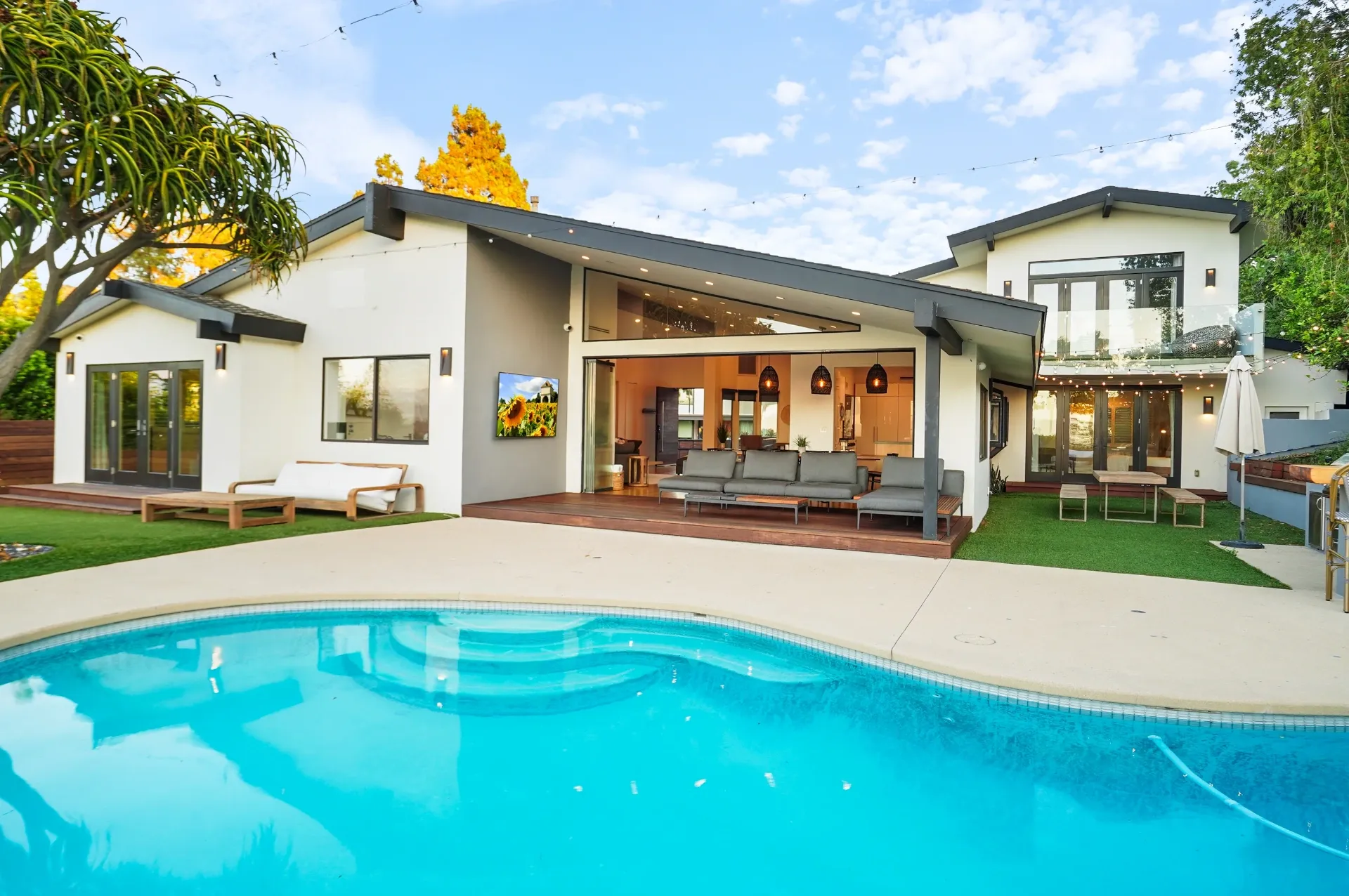 11308 Dona Teresa Dr — Backyard: Evening view of indoor-outdoor living space with pool and seamless interior connection
