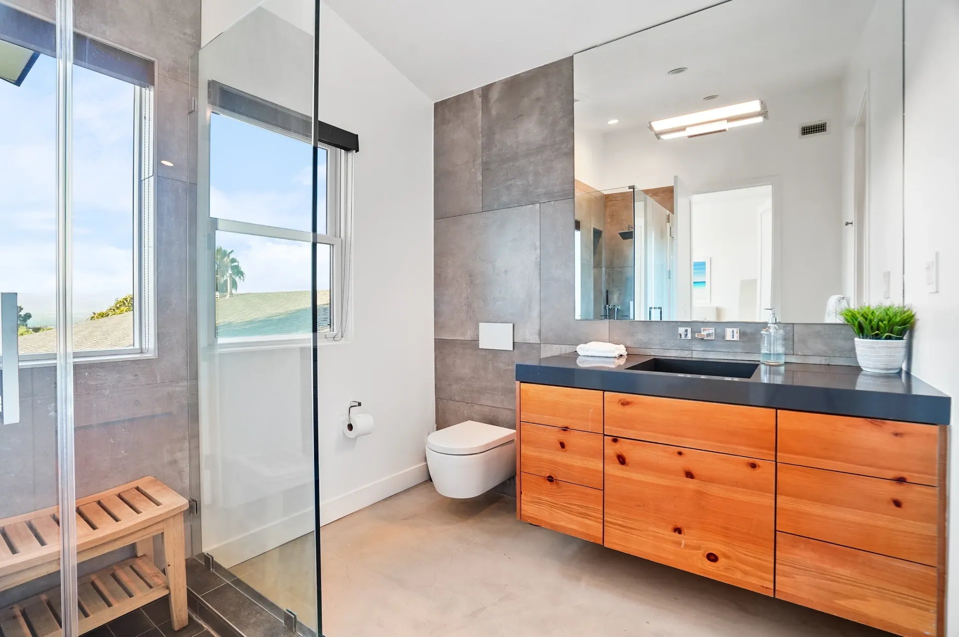 11308 Dona Teresa Dr — Bathrooms: Modern bathroom with floating wood vanity, glass shower, and hillside views