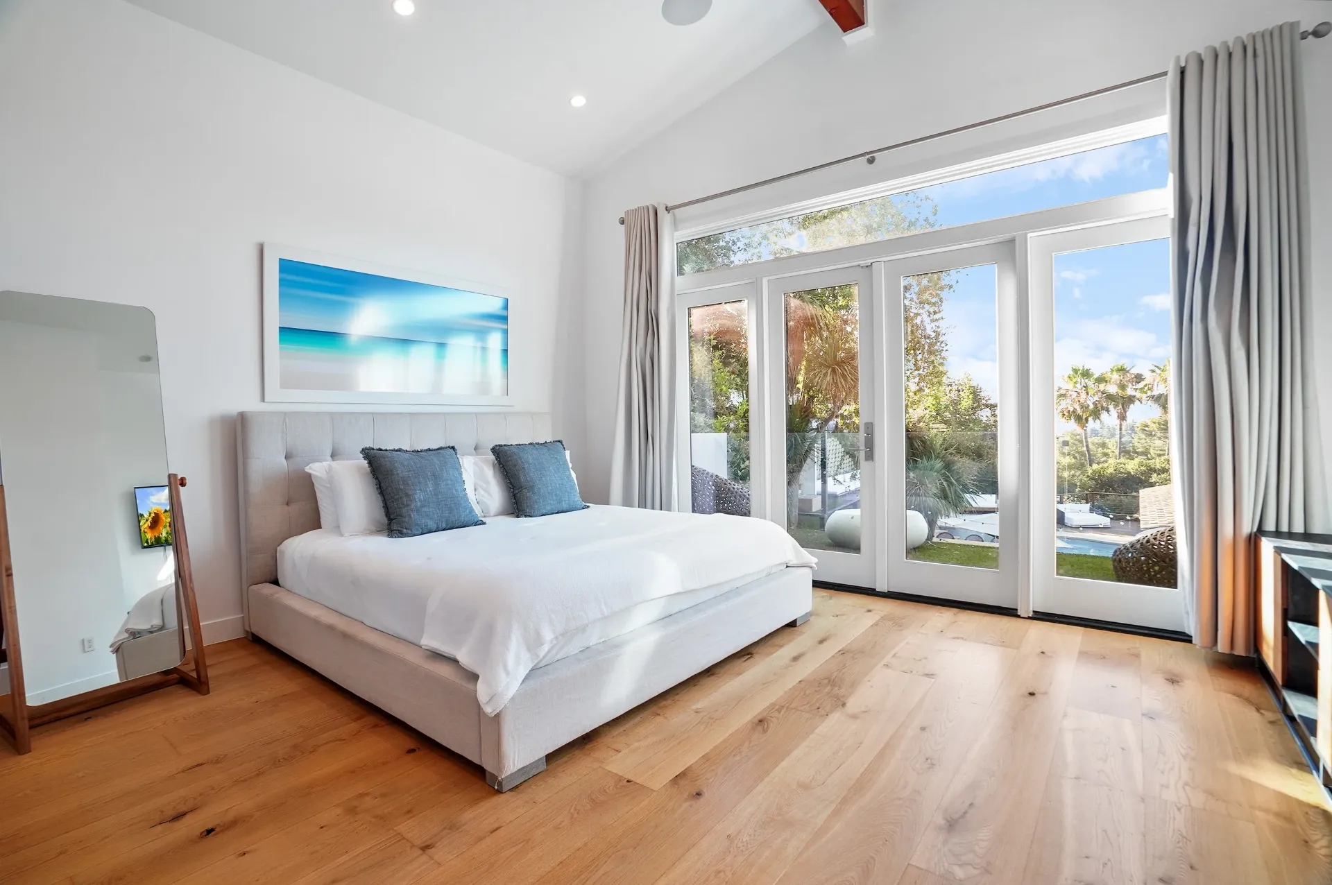 11308 Dona Teresa Dr — Bedrooms: Modern bedroom with upholstered bed, French doors to pool area, and natural light