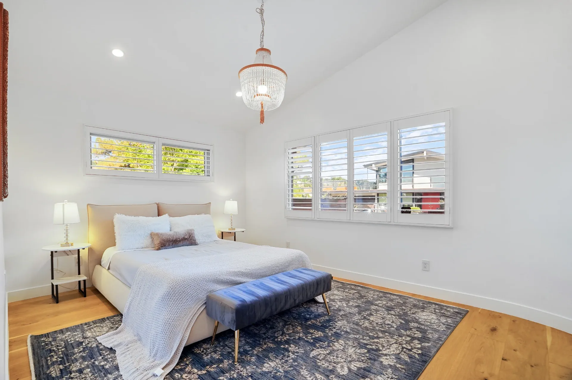 11308 Dona Teresa Dr — Bedrooms: Elegant bedroom with crystal chandelier, upholstered bench, and large windows