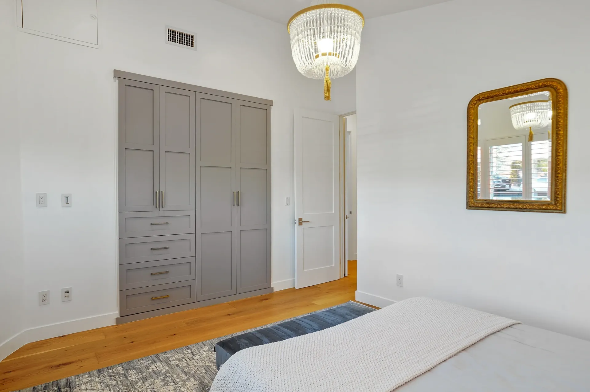11308 Dona Teresa Dr — Bedrooms: Primary bedroom with custom gray built-in wardrobes and brass chandelier