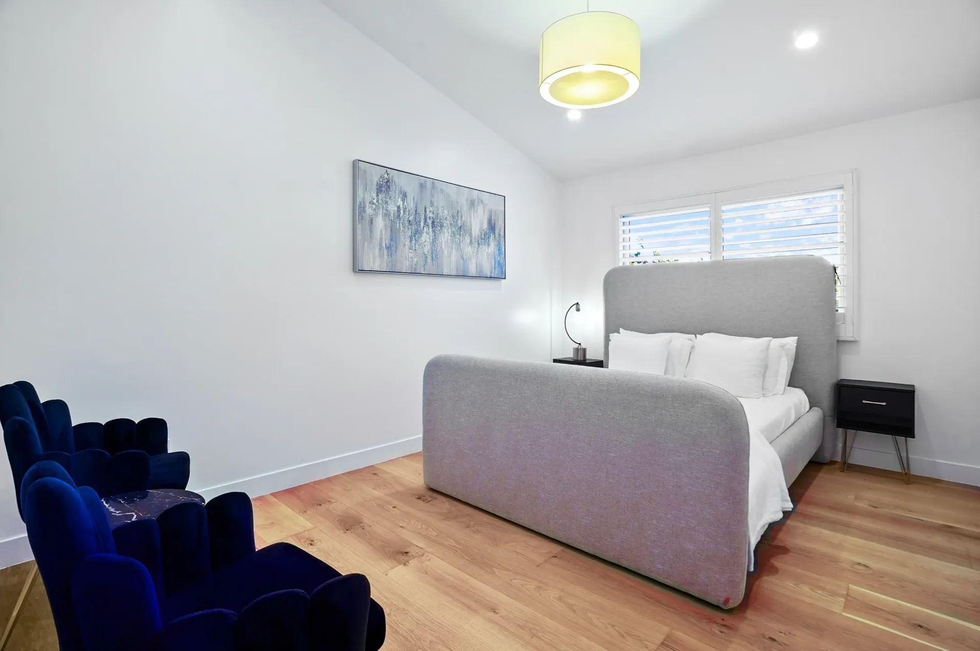 11308 Dona Teresa Dr — Bedrooms: Contemporary bedroom with navy velvet chairs and modern pendant lighting