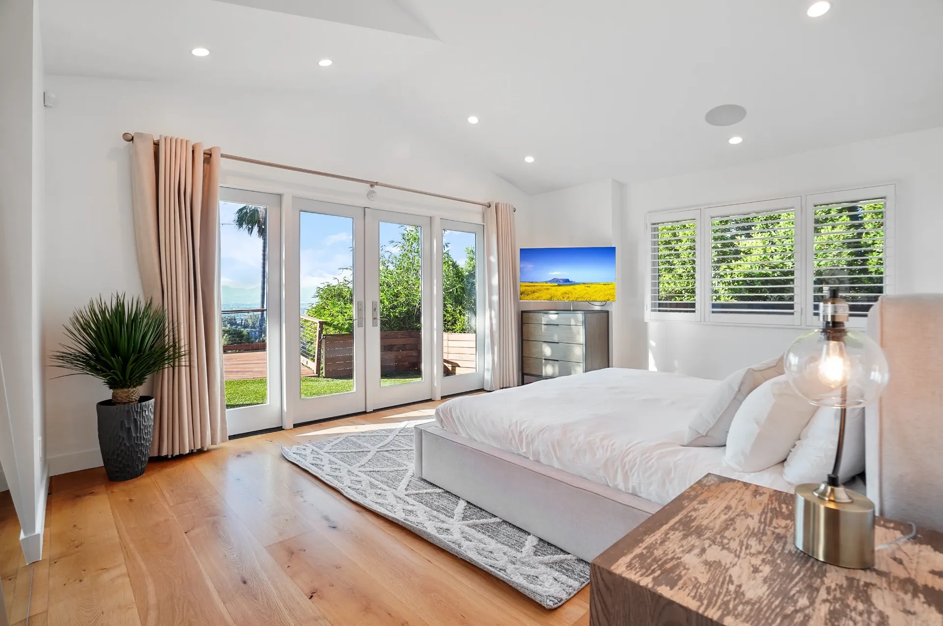 11308 Dona Teresa Dr — Bedrooms: Spacious primary bedroom with French doors to outdoor space and modern furnishings