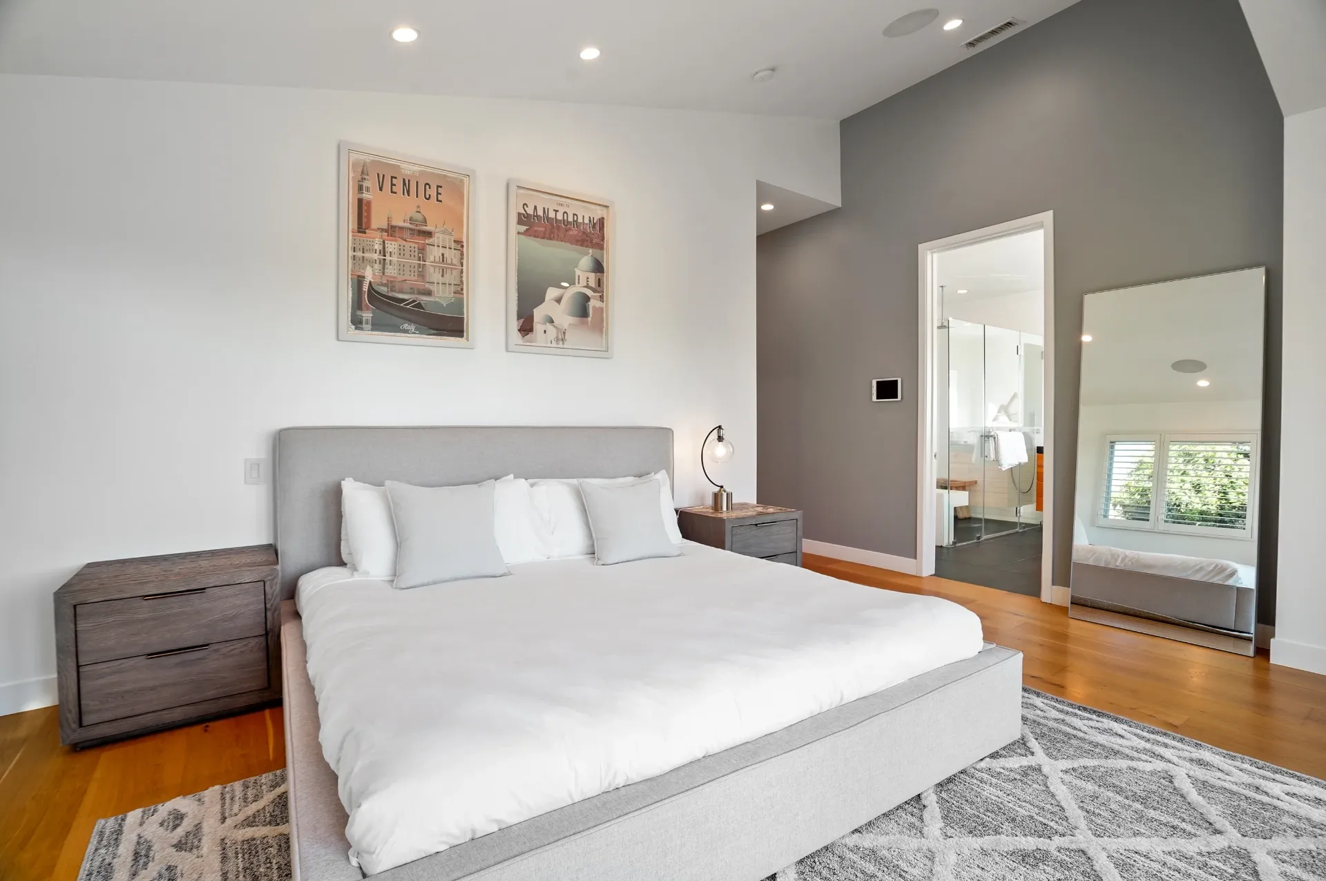 11308 Dona Teresa Dr — Bedrooms: Contemporary bedroom with gray accent wall, vintage travel posters, and spa like bathroom access