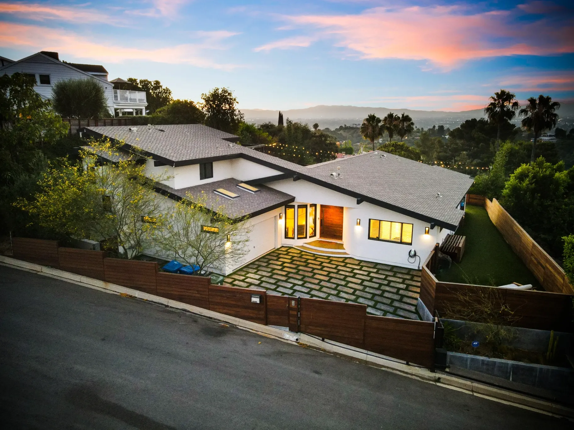 11308 Dona Teresa Dr — Exterior: Twilight aerial view with dramatic sky and warm interior lighting against Studio City hillside setting