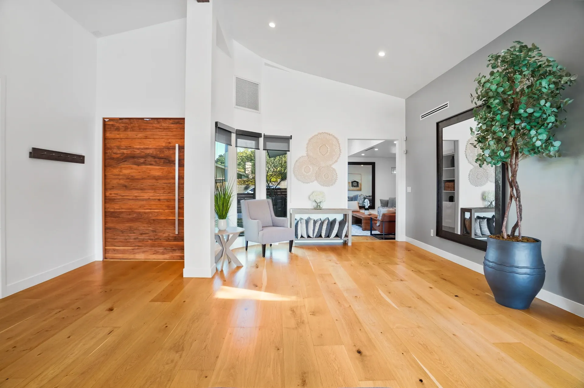 11308 Dona Teresa Dr — Living Areas: Entry living space with modern wood door and designer furnishings