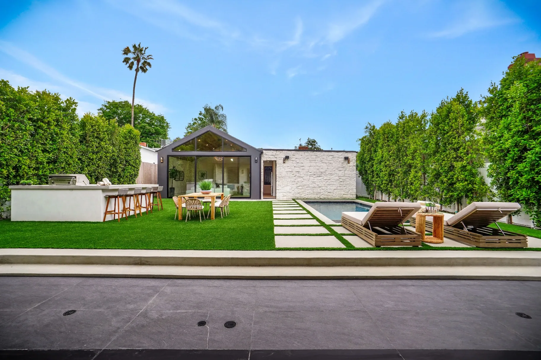 15602 Morrison St — Backyard: Modern backyard with rectangular pool, spa, and artificial grass landscaping