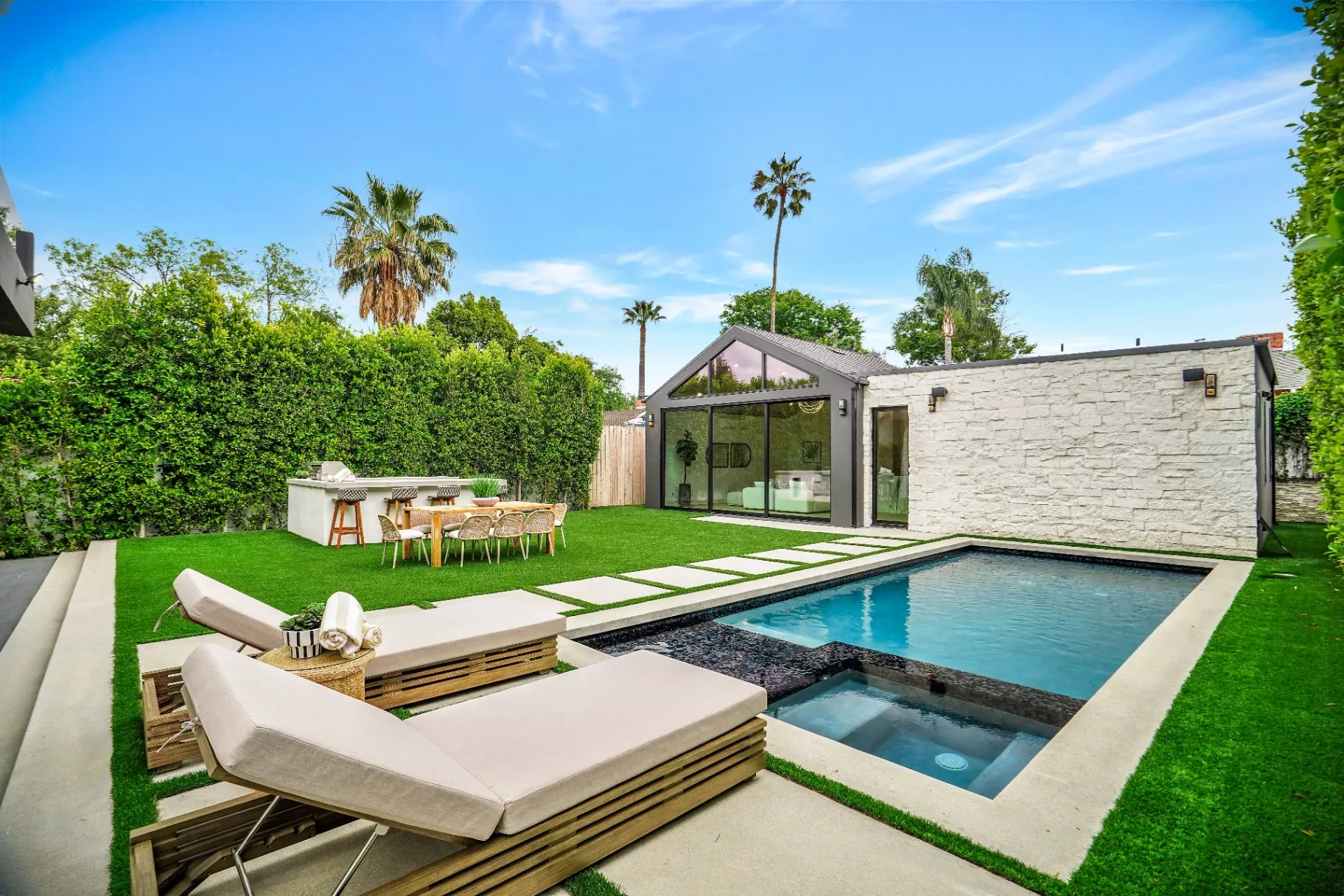 15602 Morrison St — Backyard: Resort-style pool with spa, lounge chairs, and outdoor kitchen area